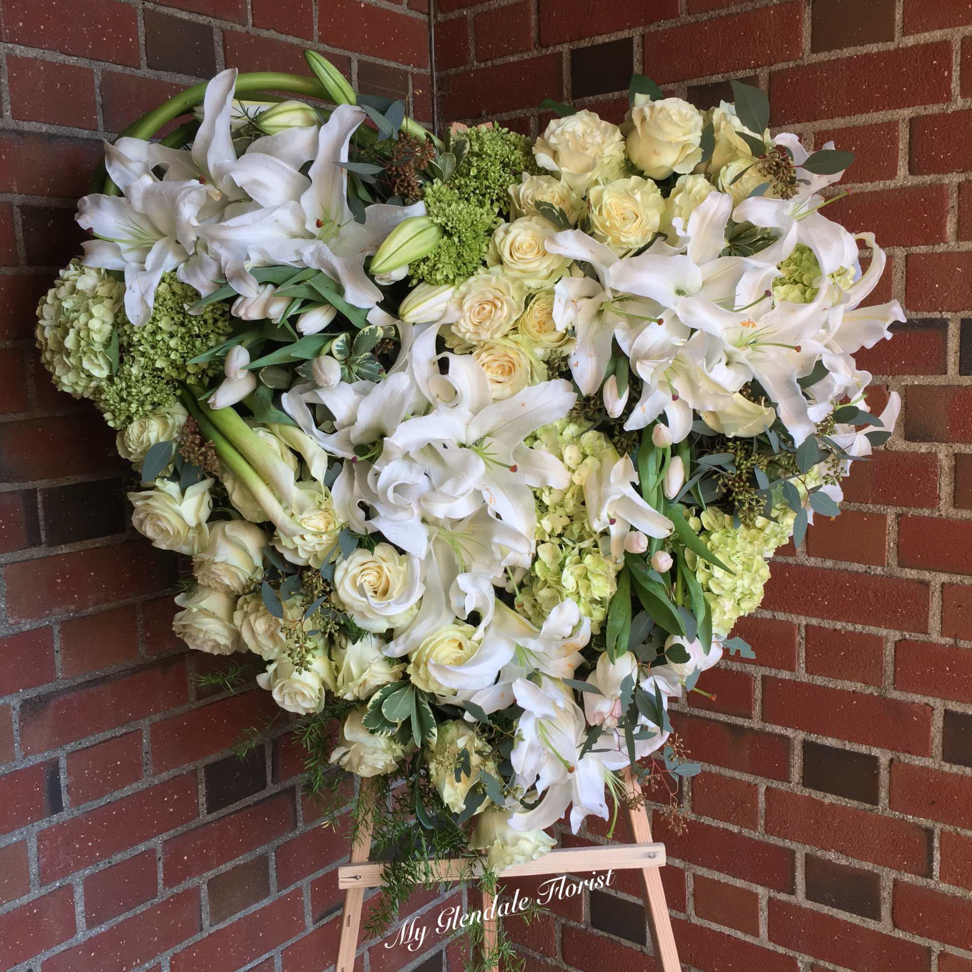 This unique design consists of lilies, callas, roses and hydrangeas. 