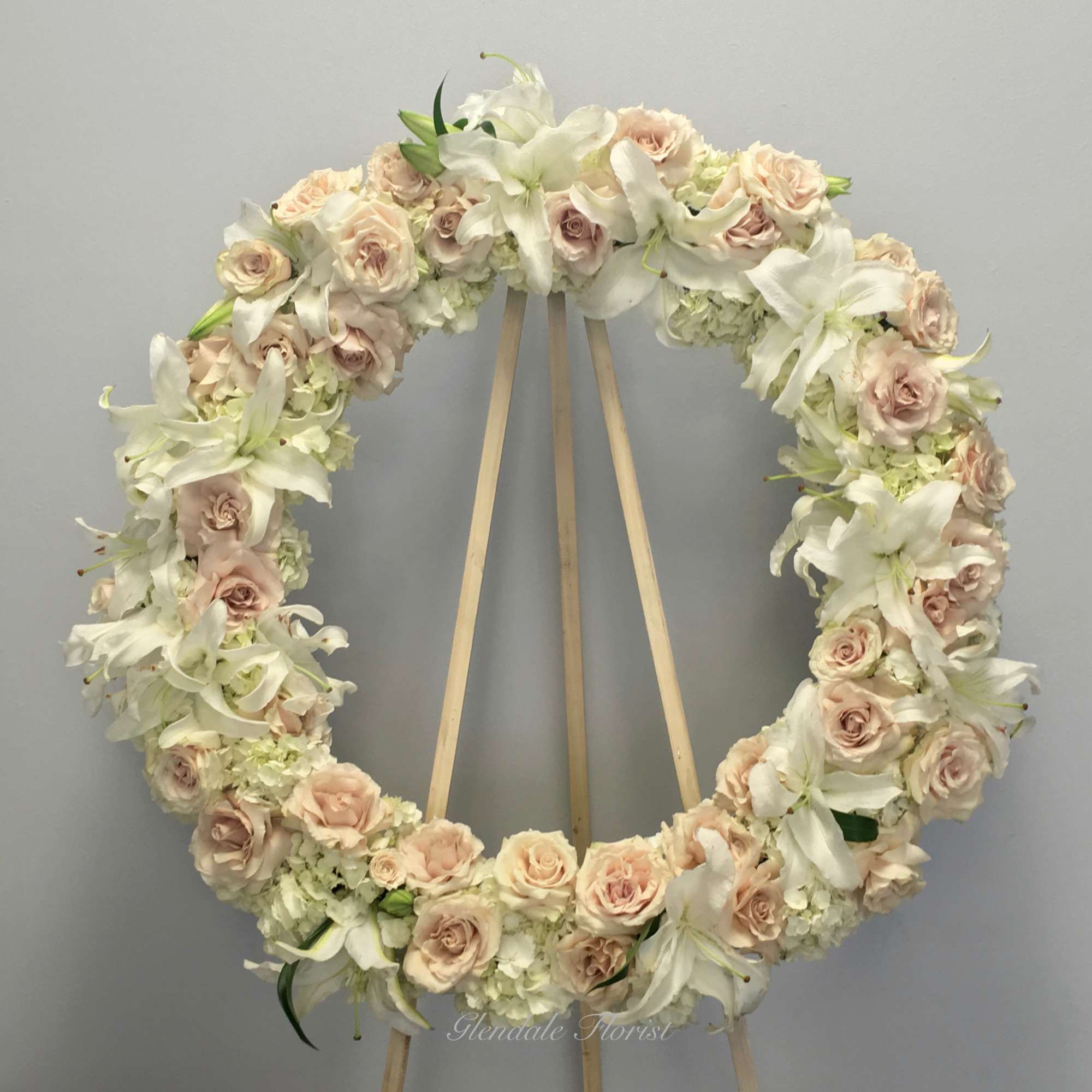 All White roses, hydrangeas, orchids, and lilies. 

We include easel, printed banner