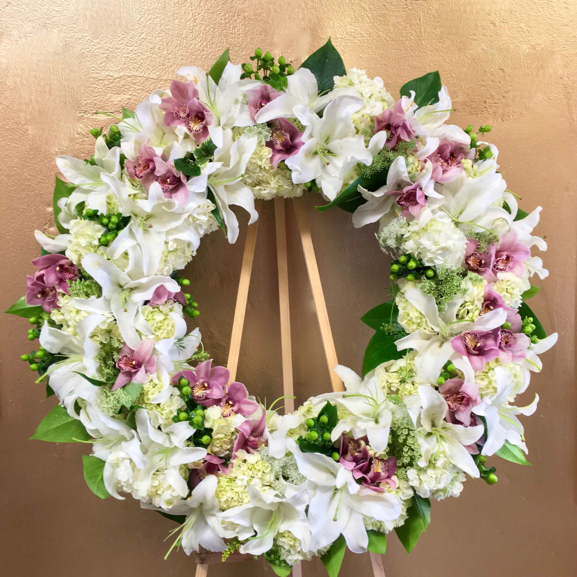 Orchids, lilies, and hydrangeas wreath. Standard size measures approximately 30 inches wide.