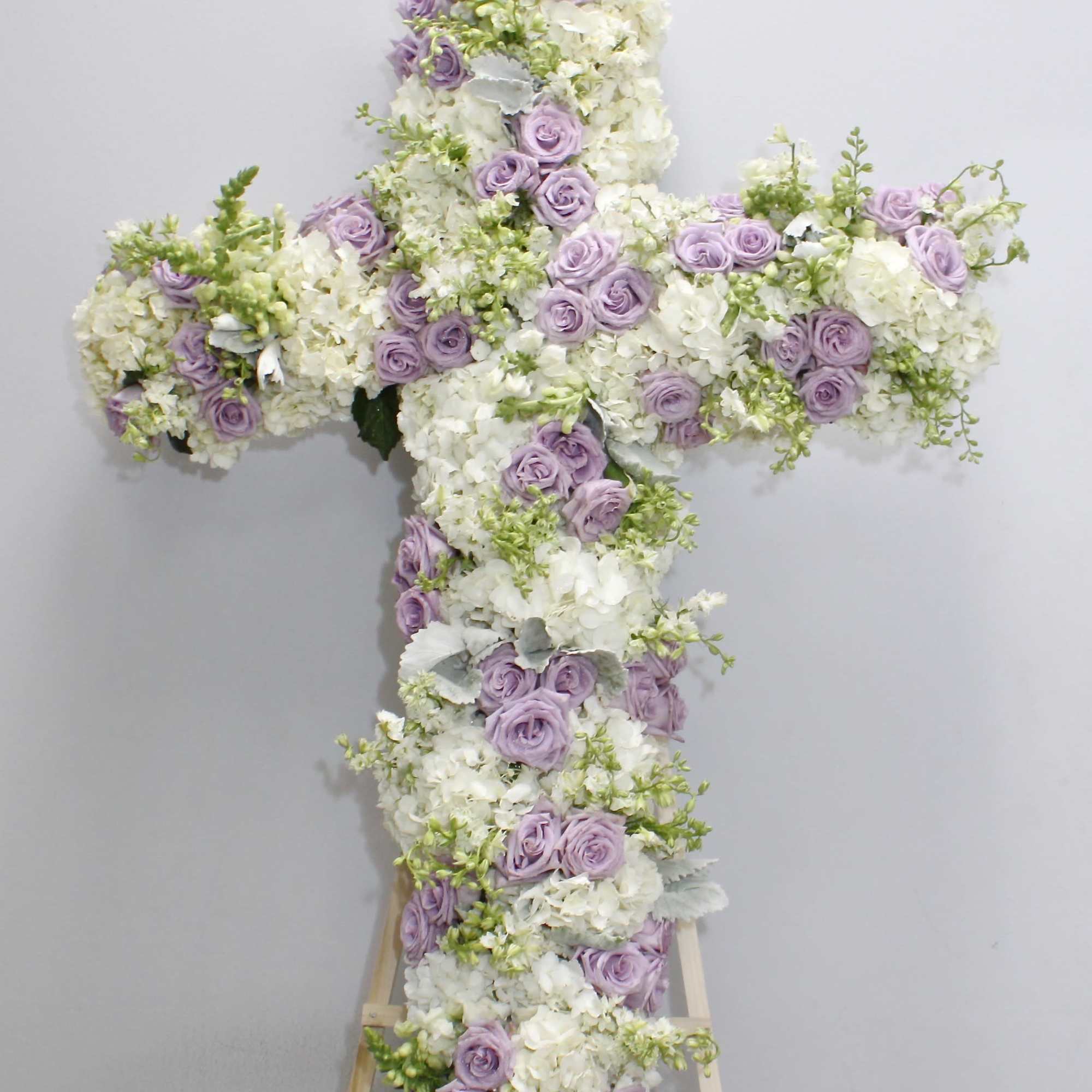 This cross is made a delicate blend of lavender roses, hydrangeas and