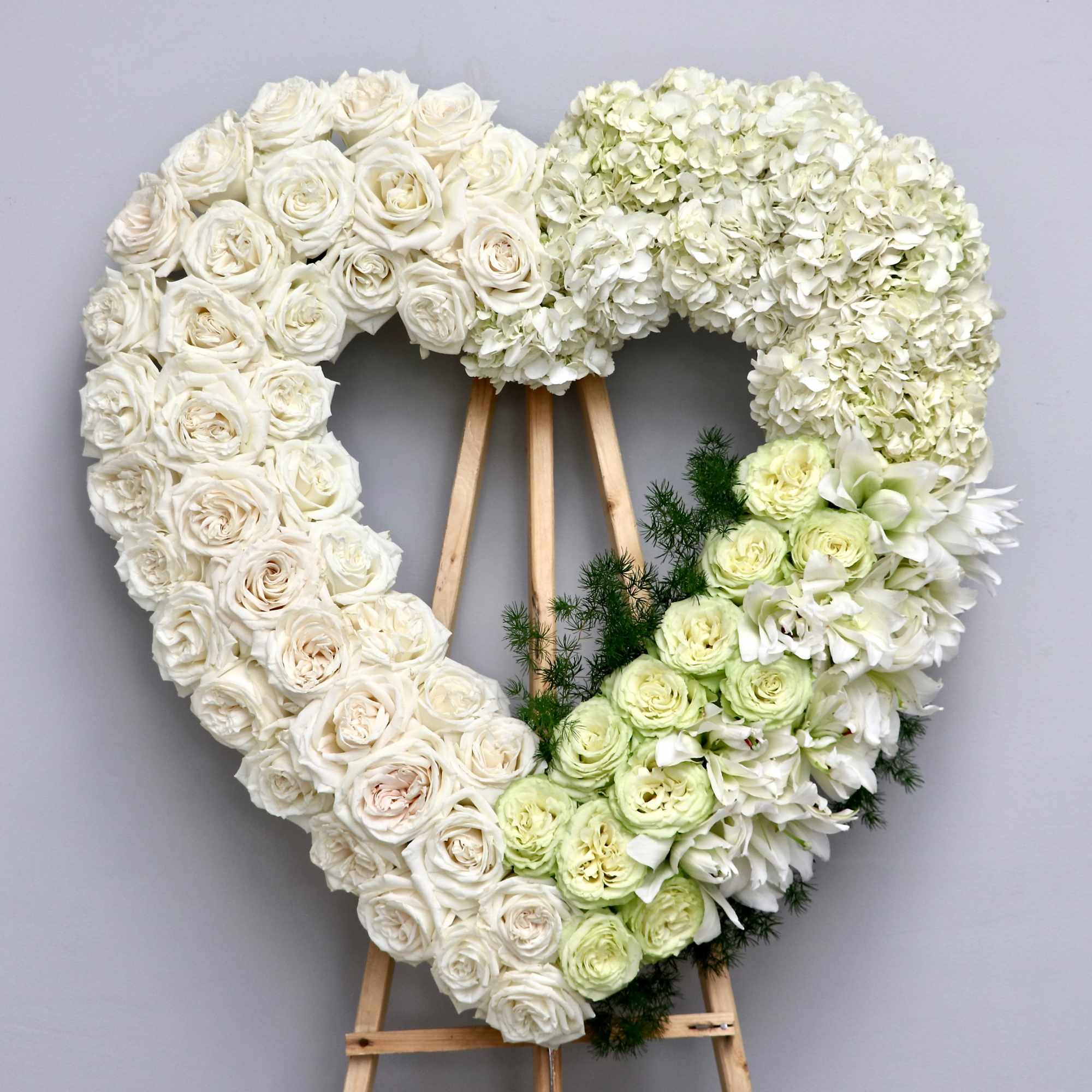 Half white roses and half white hydrangeas, this heart also contains a