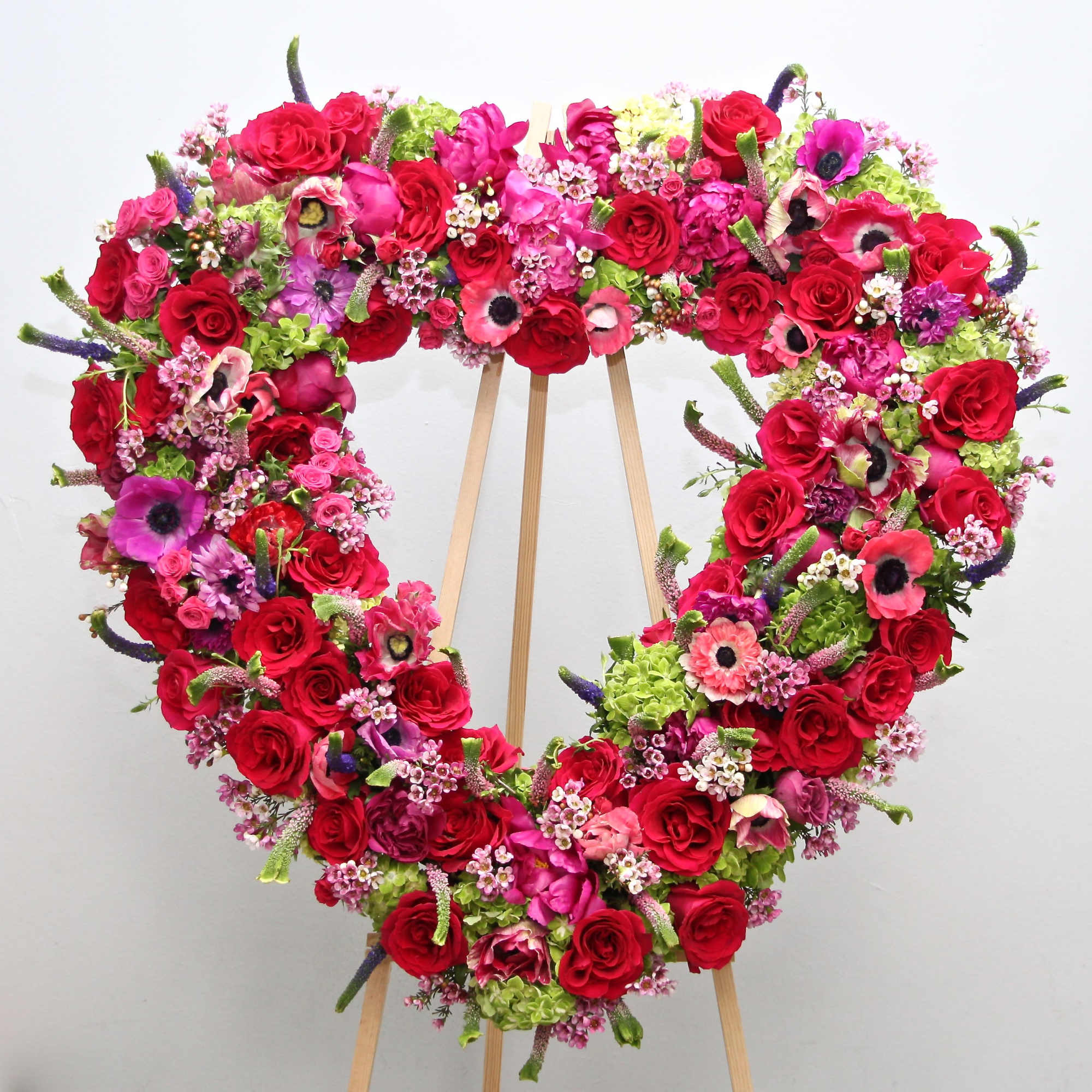 This heart includes bright pink roses, hydrangeas, and seasonal greens. 

We include