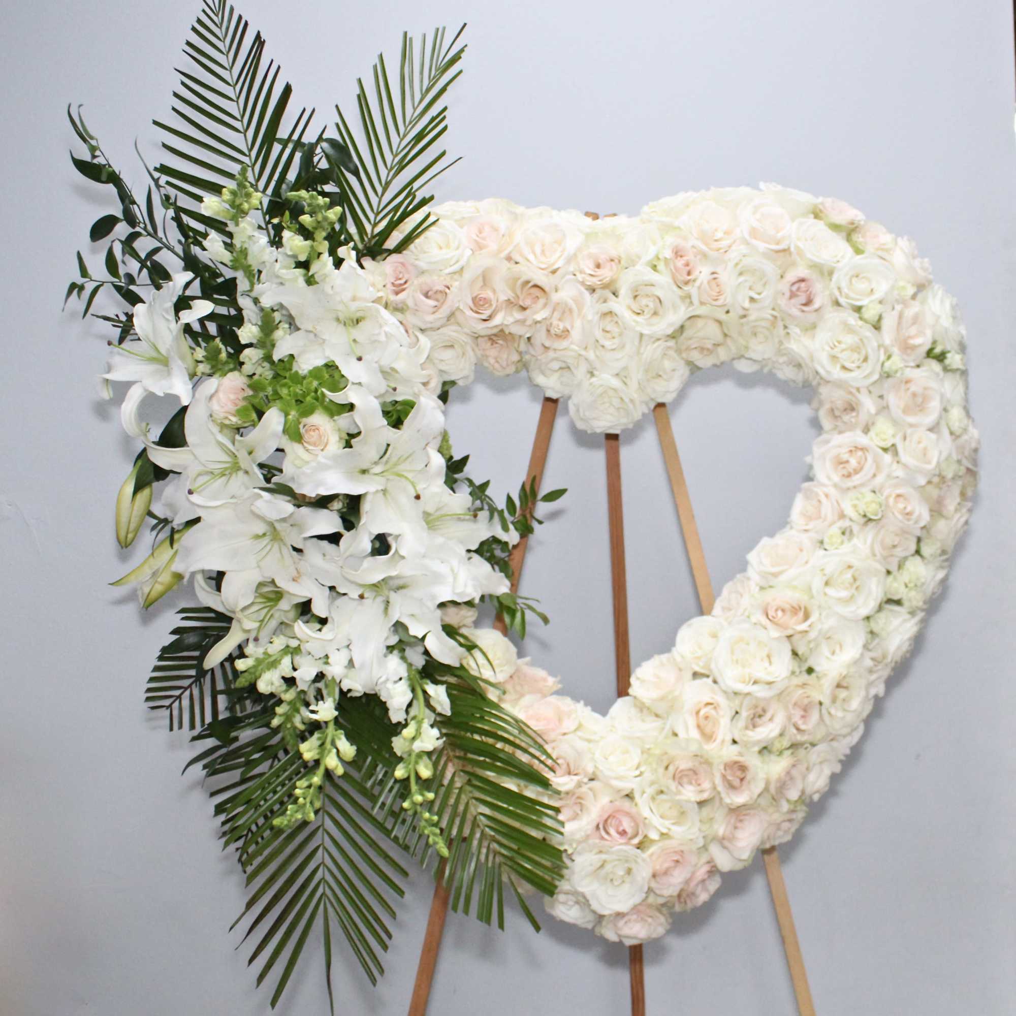 The white heart is made up of white roses, stargazer lilies and