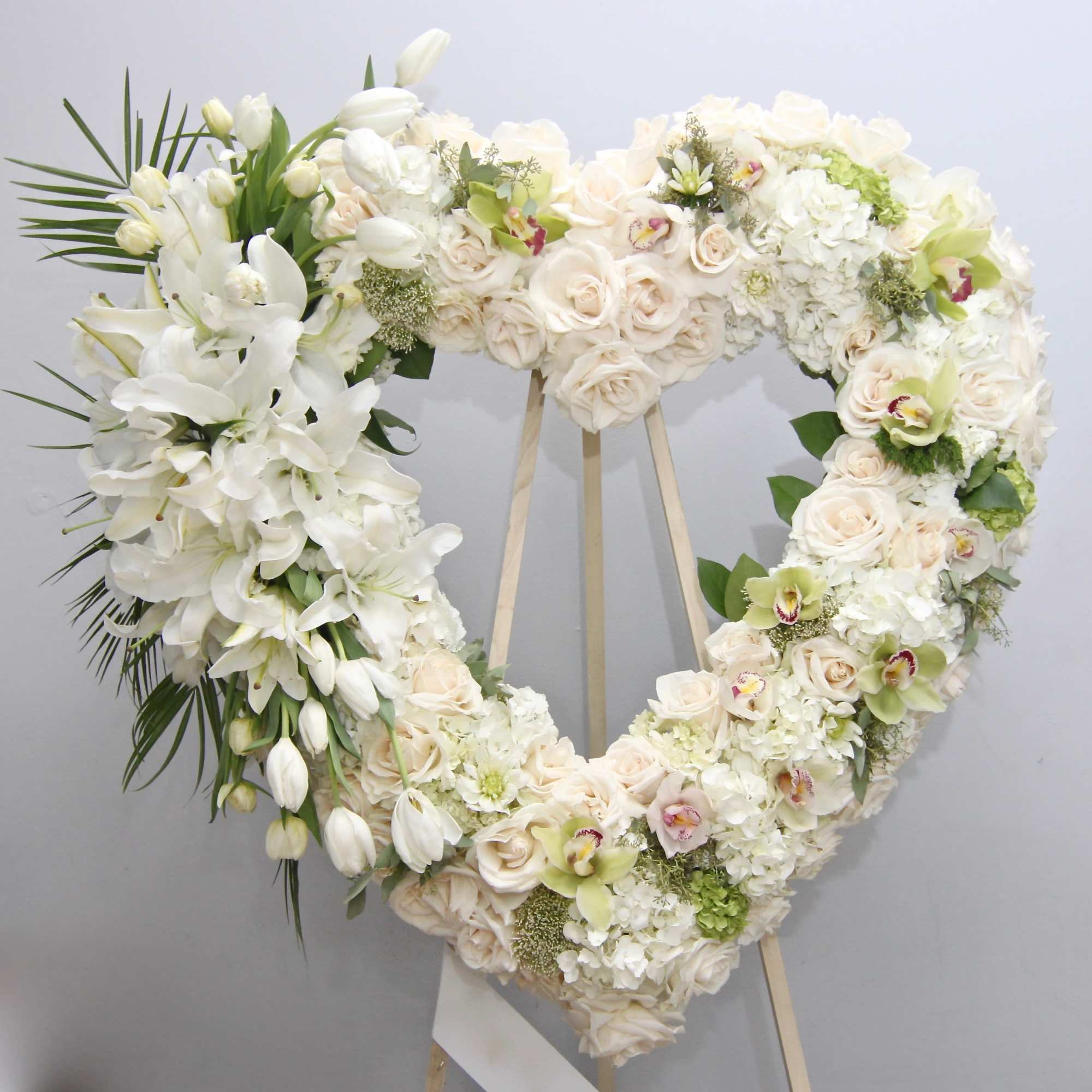 Arranged on a base of roses and hydrangeas, this heart also contains