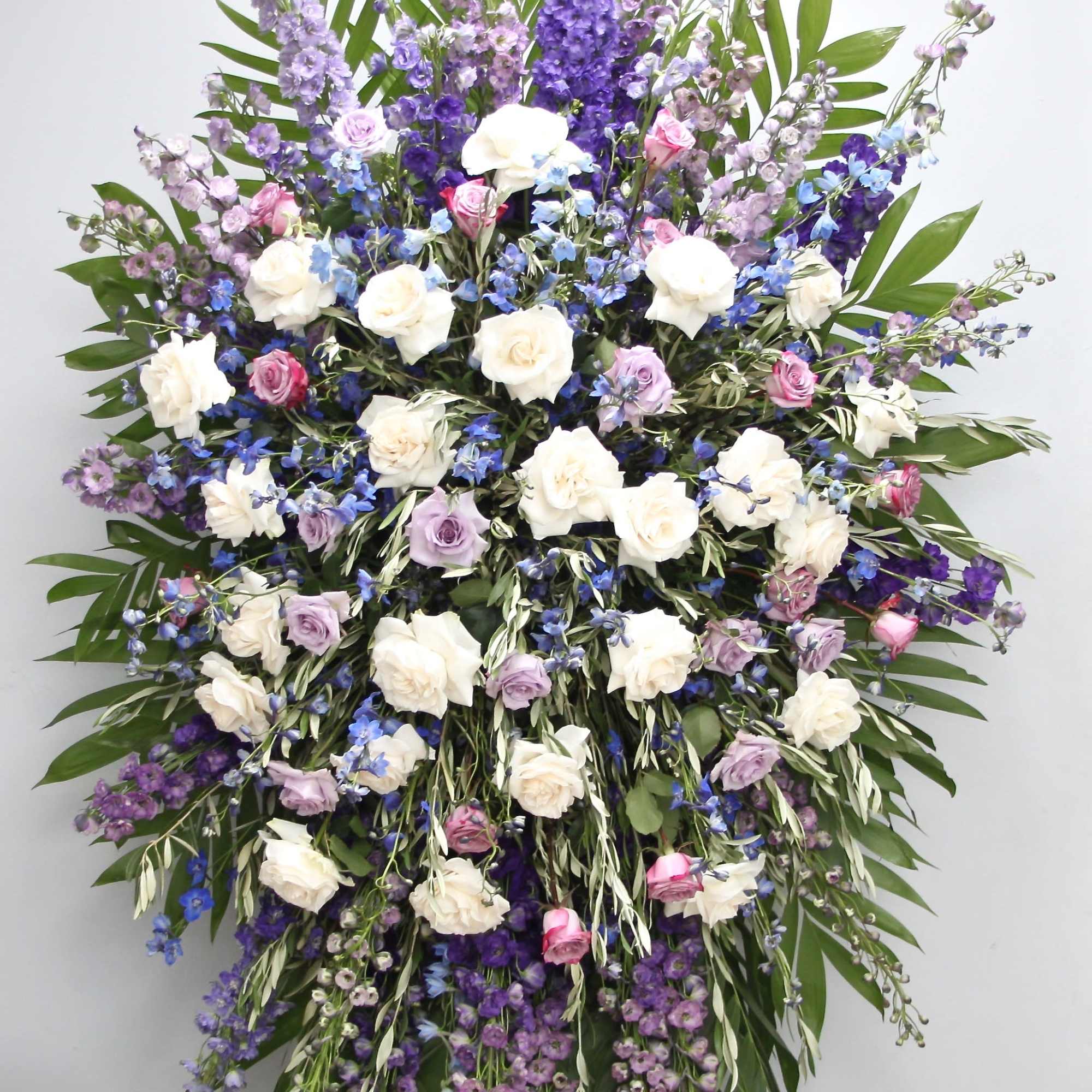 This sympathy spray includes vibrant colors of lavender and purple. It also