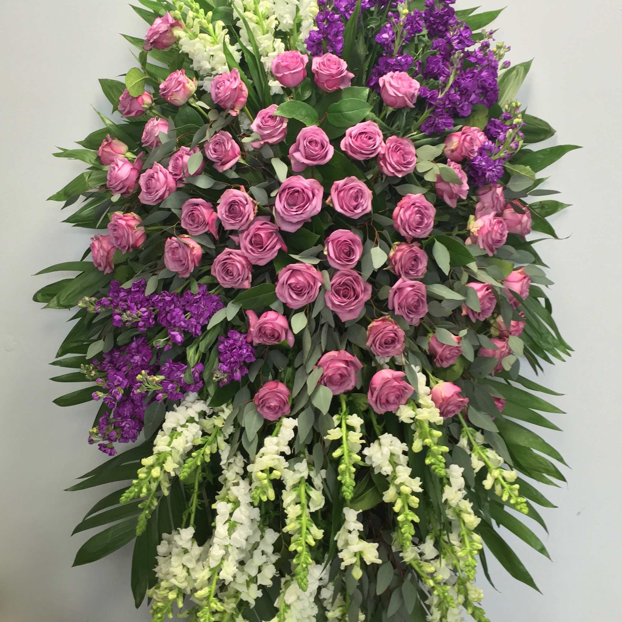 This spray contains a mix of pinks, purples and whites, all surrounded