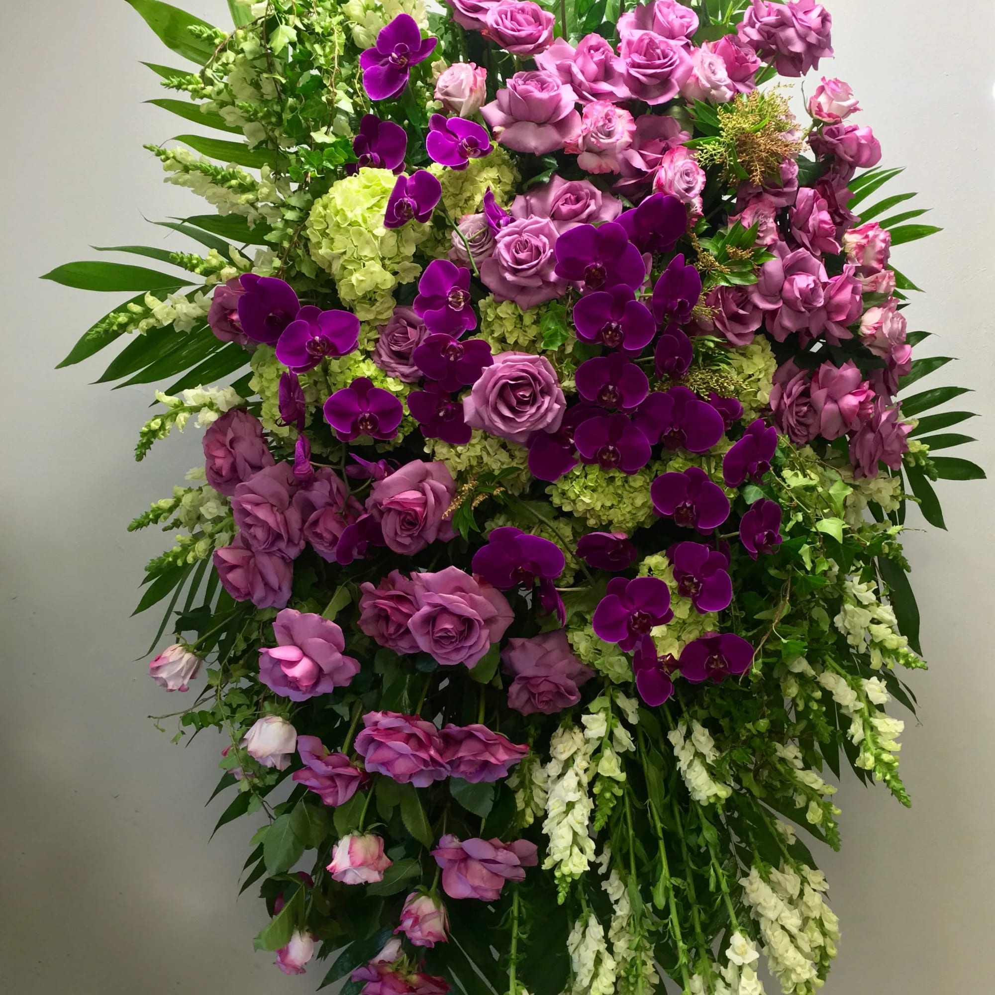 This sympathy spray contains roses, orchids, hydrangeas, and seasonal greens.

 
We include