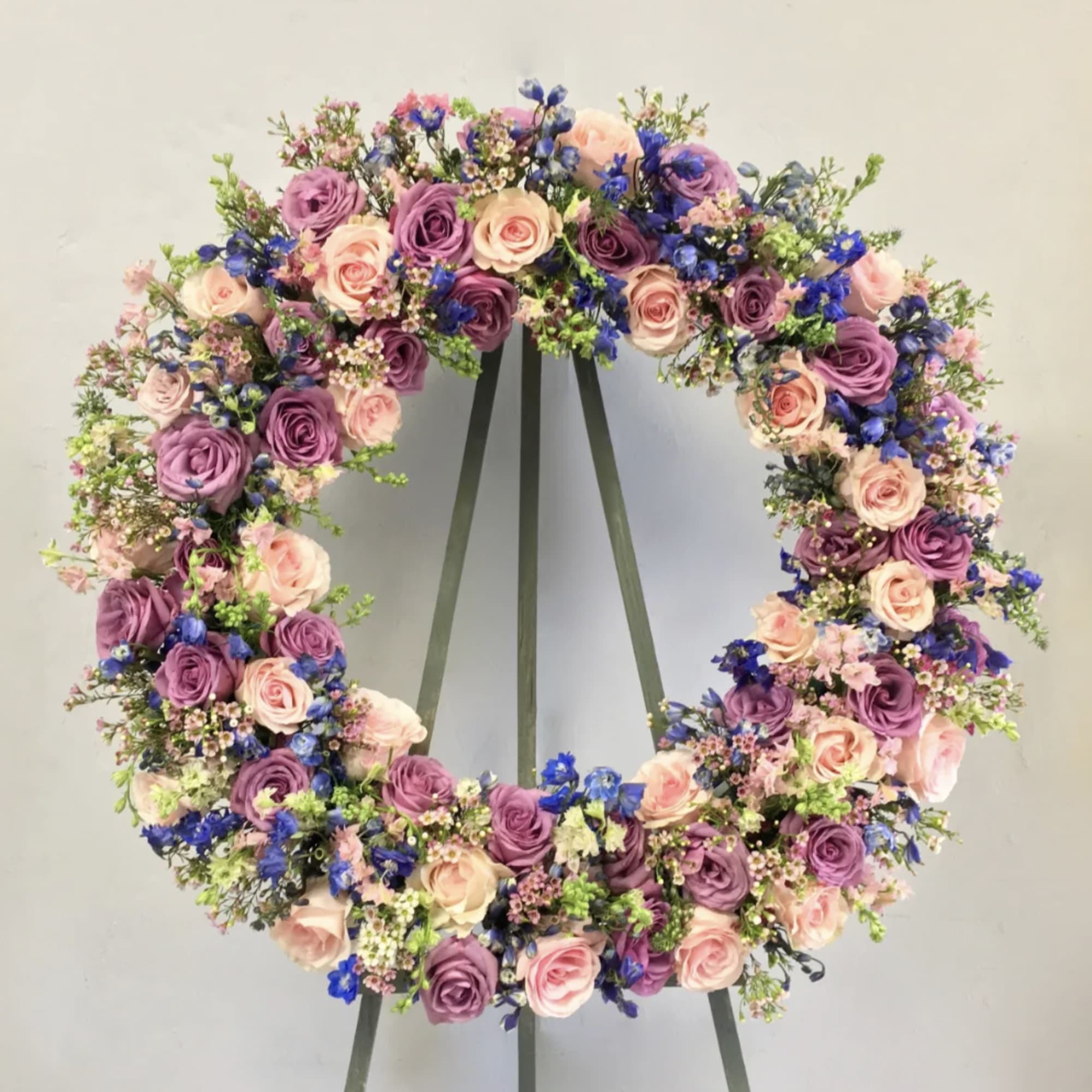 This sympathy wreath has a mix of bright colors and textures to
