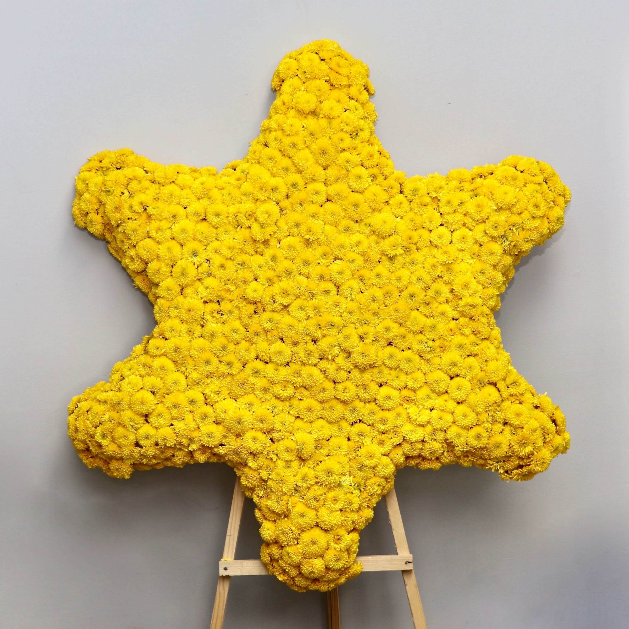 This star shaped funeral arrangement can be customized to your request. Orders