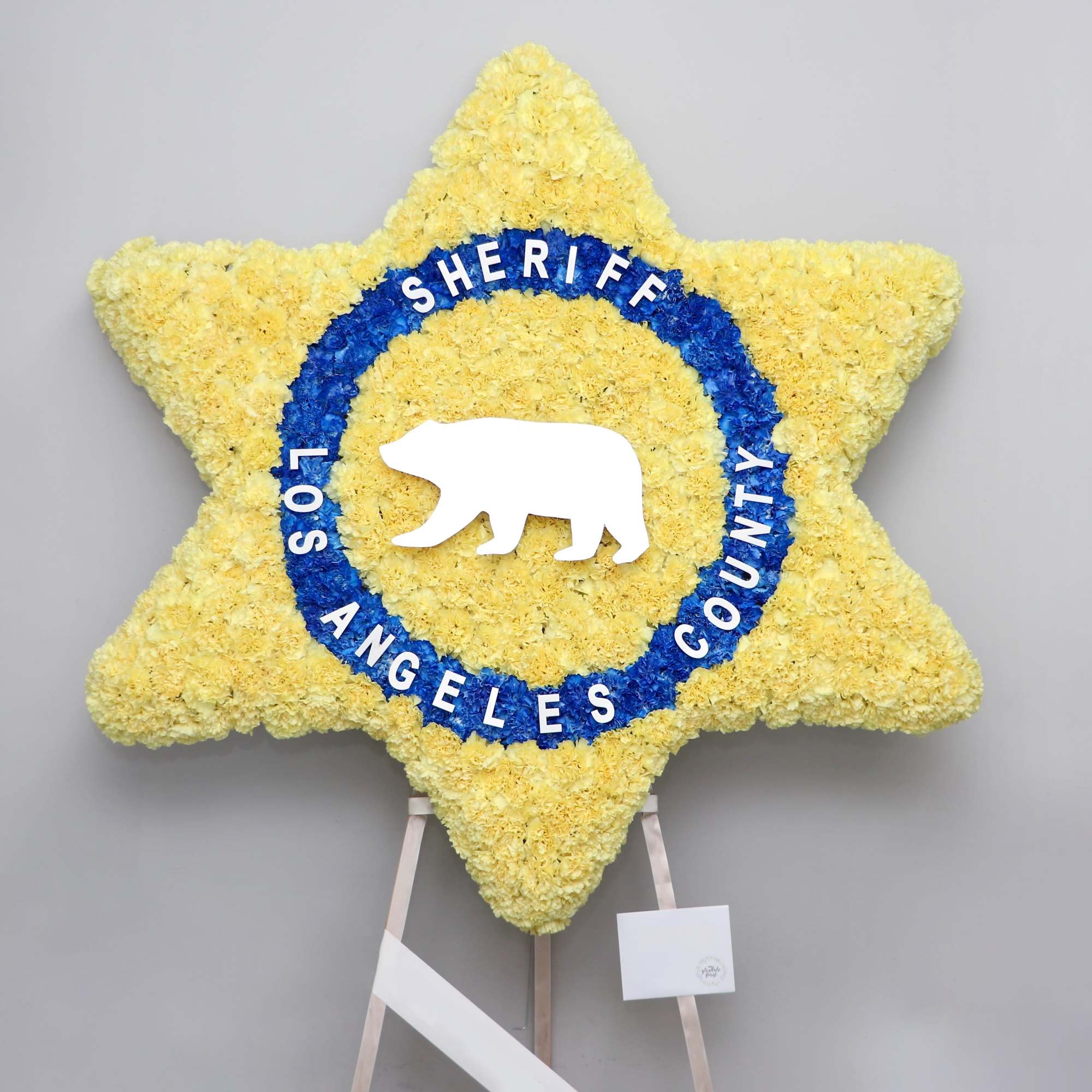 This star shaped funeral arrangement can be customized to your request. Orders