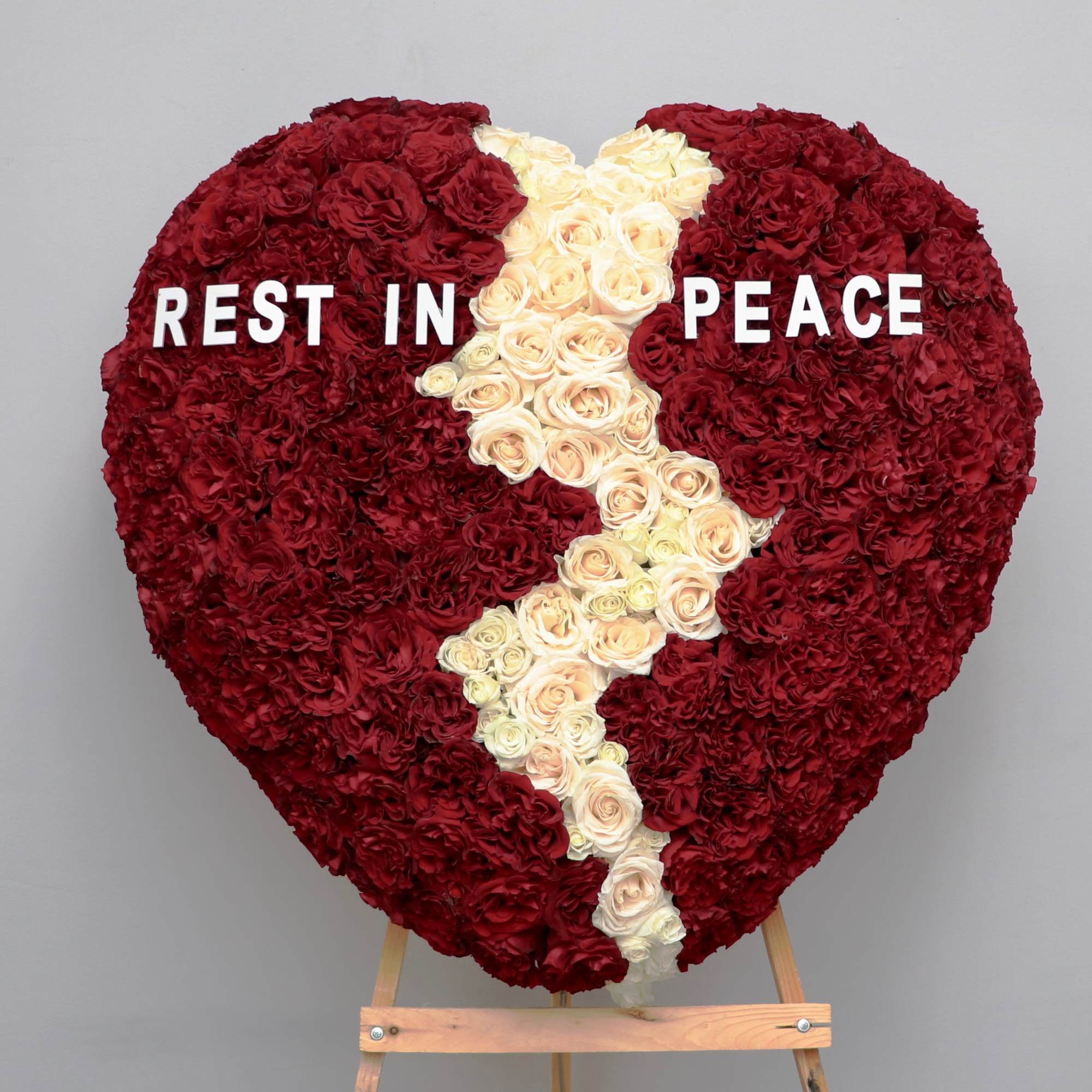 Honor a loved one with this broken heart arrangement. Featuring red and