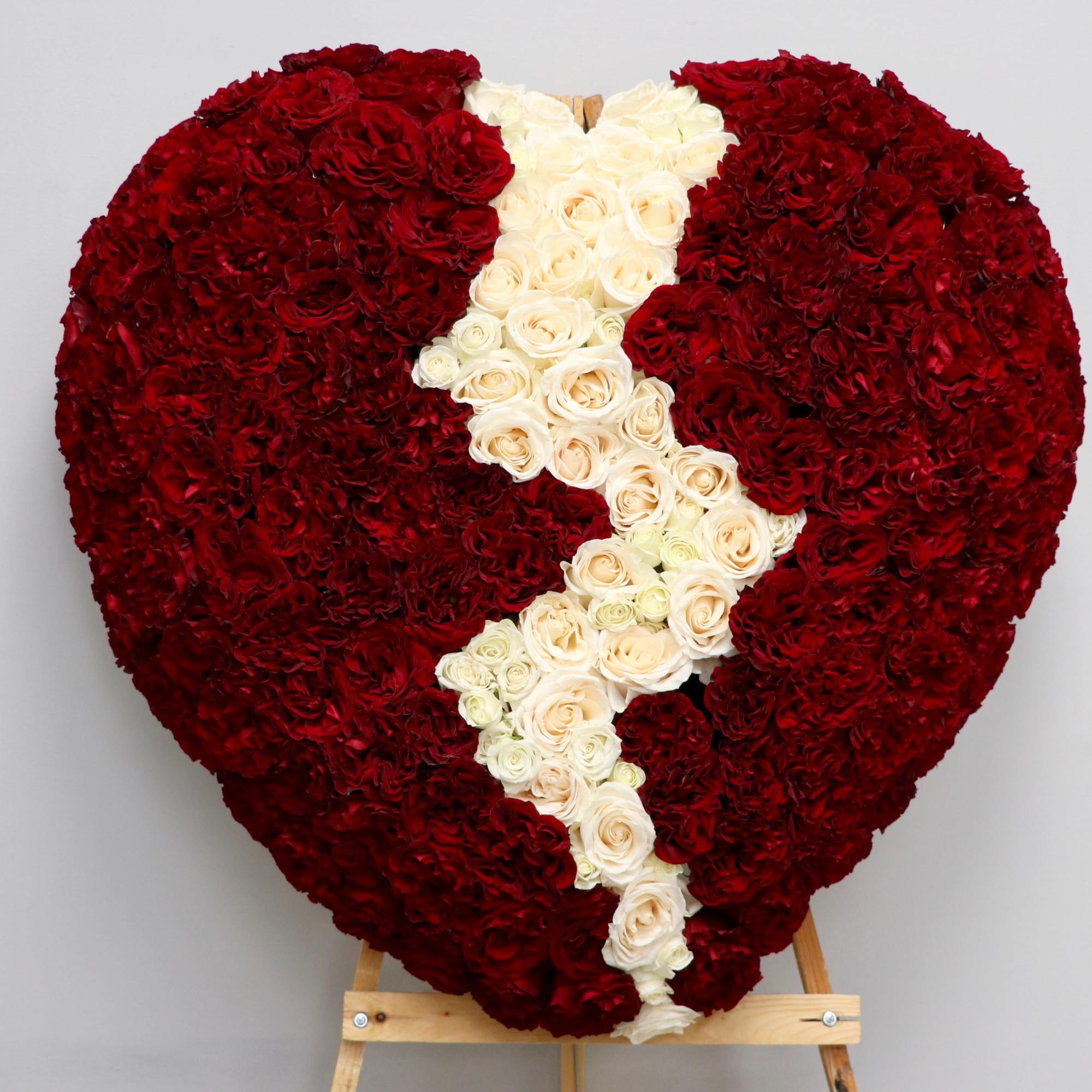 Honor a loved one with this broken heart arrangement. Featuring red and
