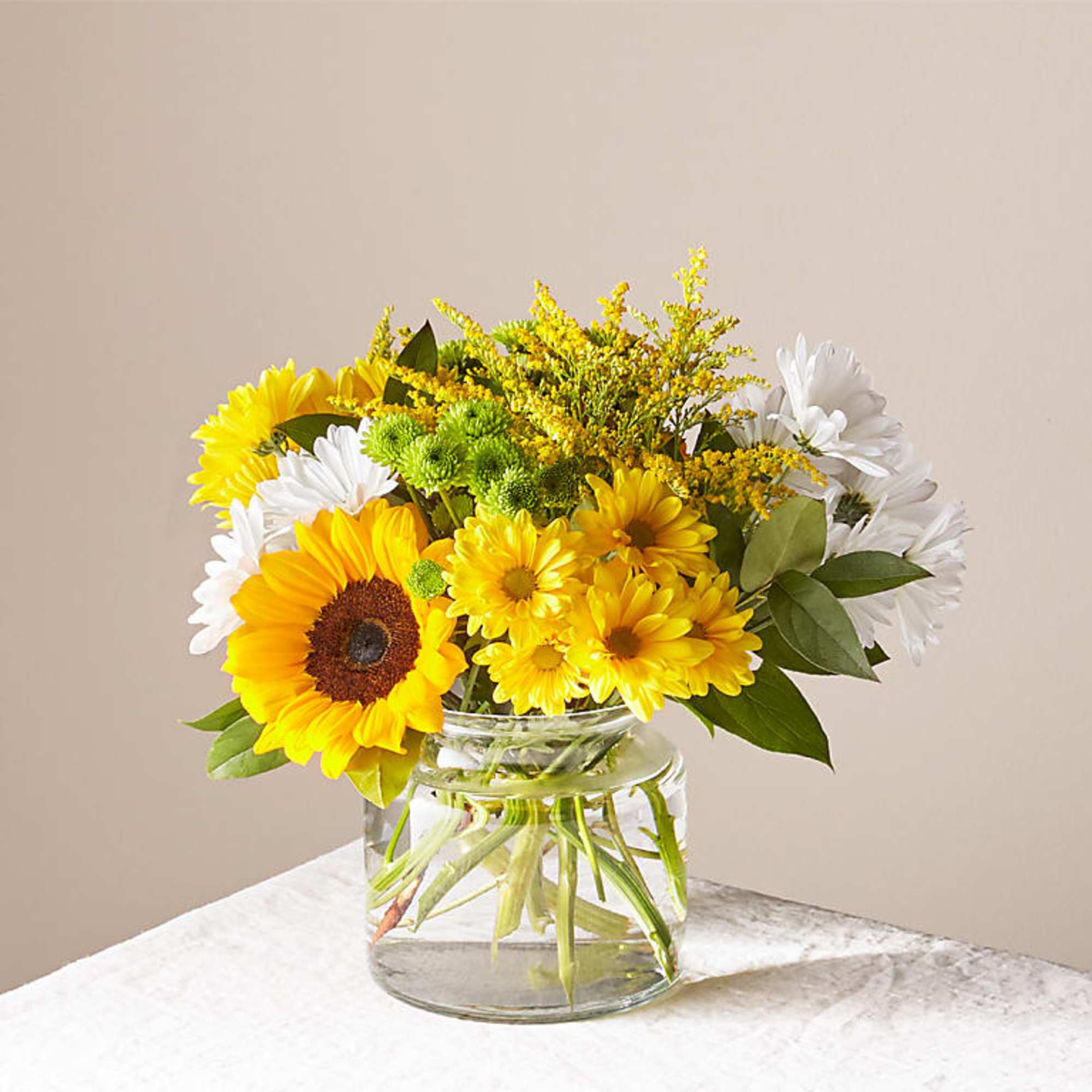 Give a dose of sunshine in bloom. This bright bouquet is brimming Give a dose of sunshine in bloom. This bright bouquet is brimming