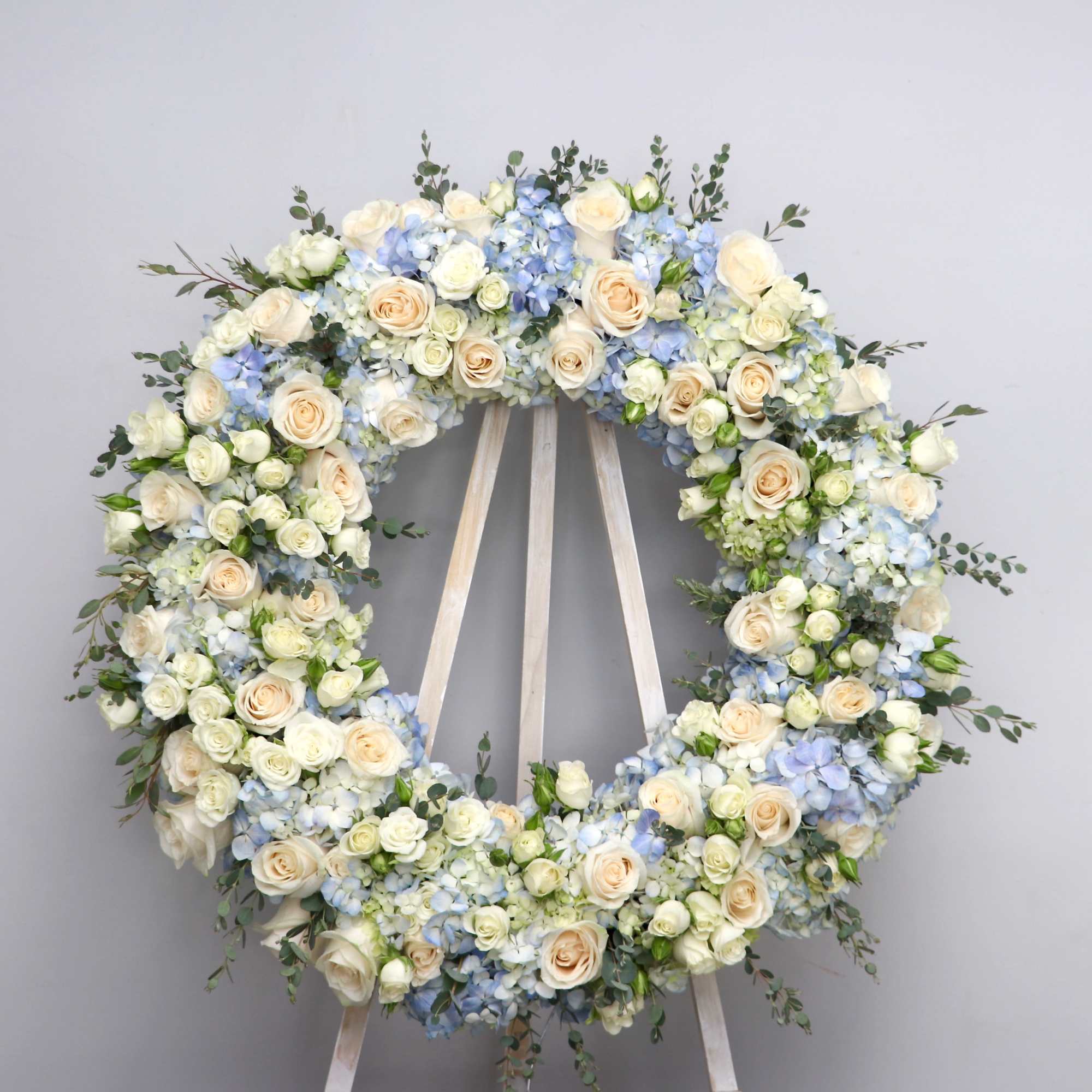 Baby blue hued florals to fill this wreath.

We include easel, printed banner