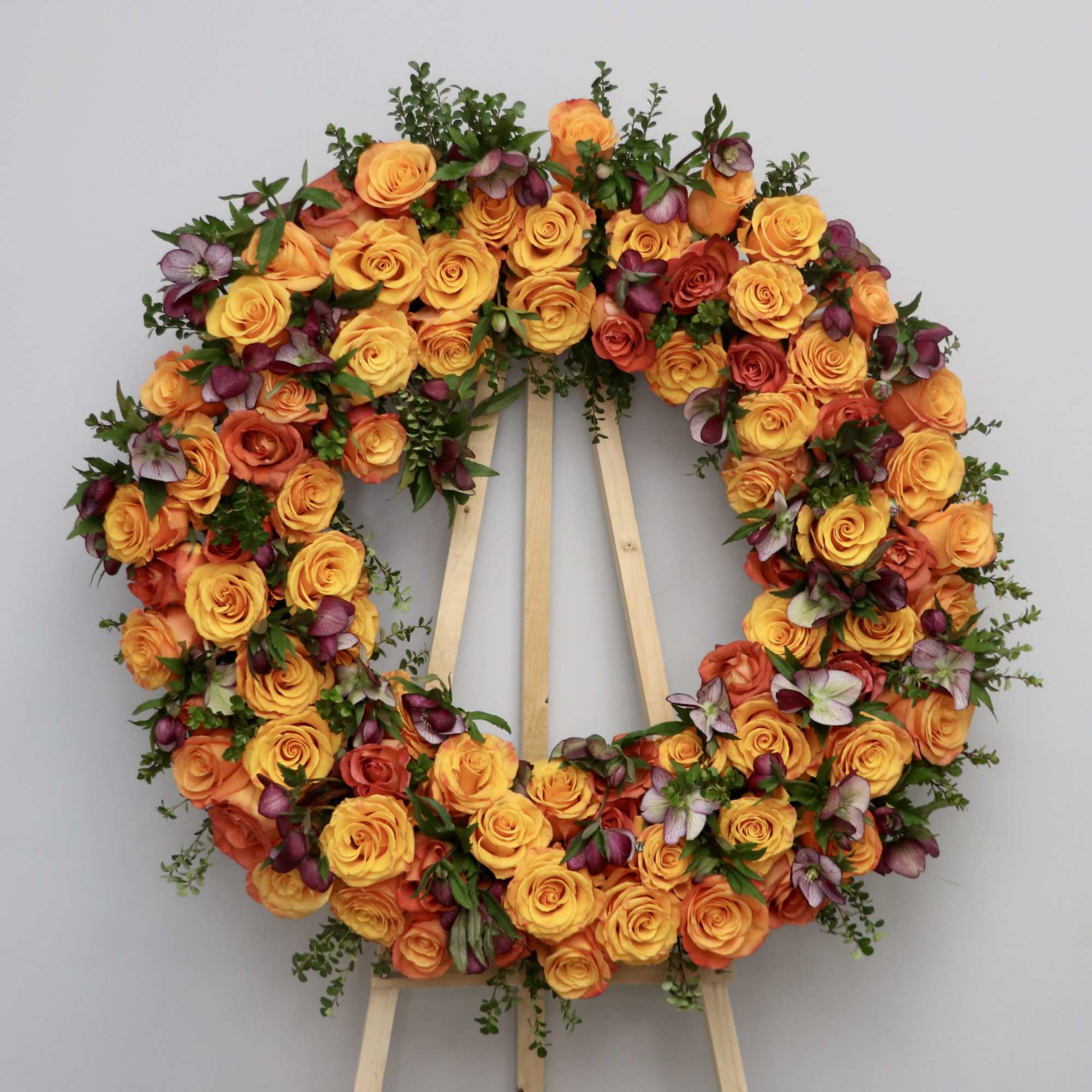 The Autumn Goodbye is a warm and elegant funeral wreath, featuring orange