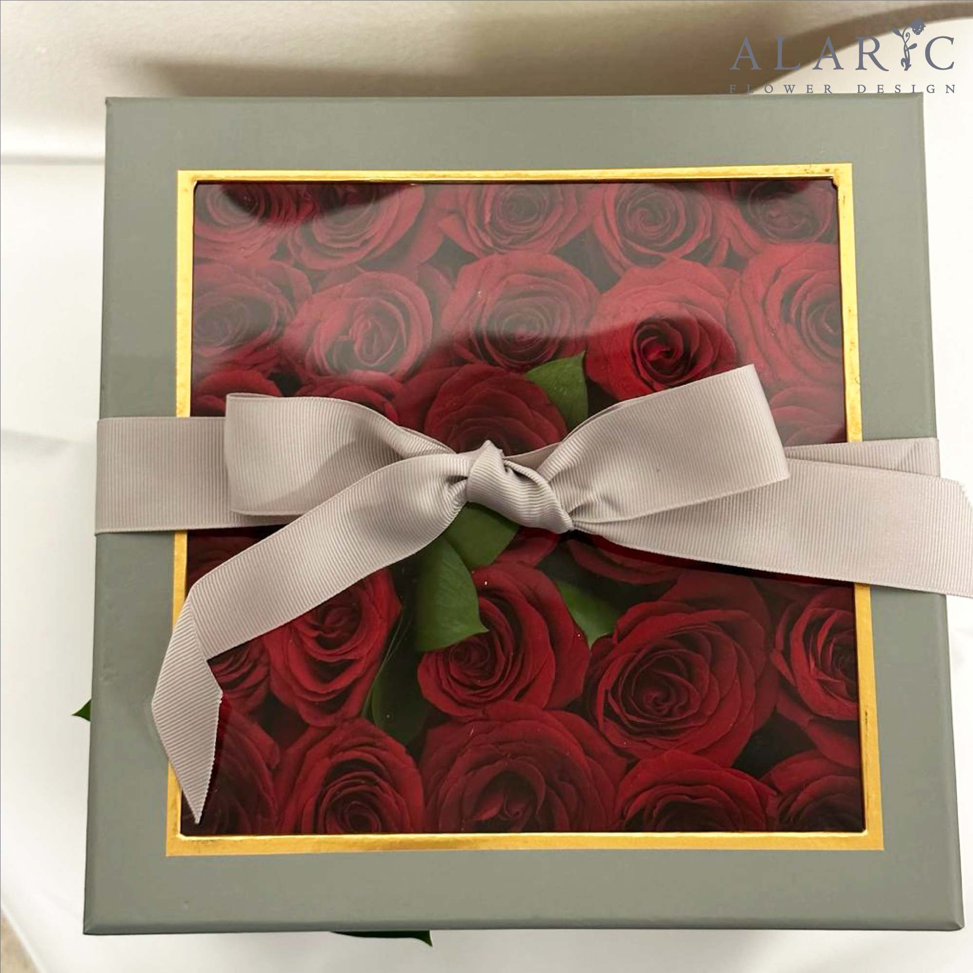 A simple square box filled with red roses!

Note: The color of the