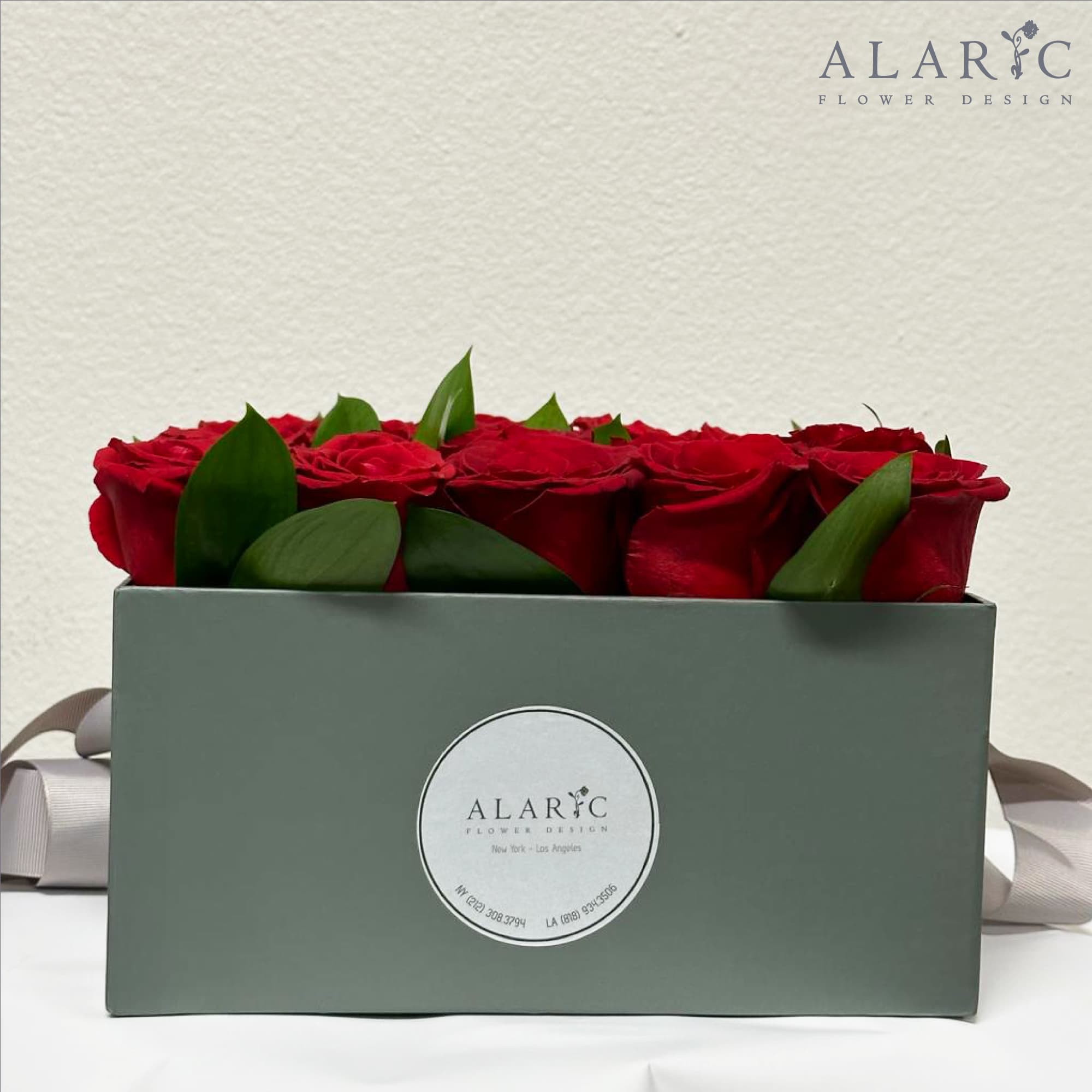 A simple square box filled with red roses!

Note: The color of the