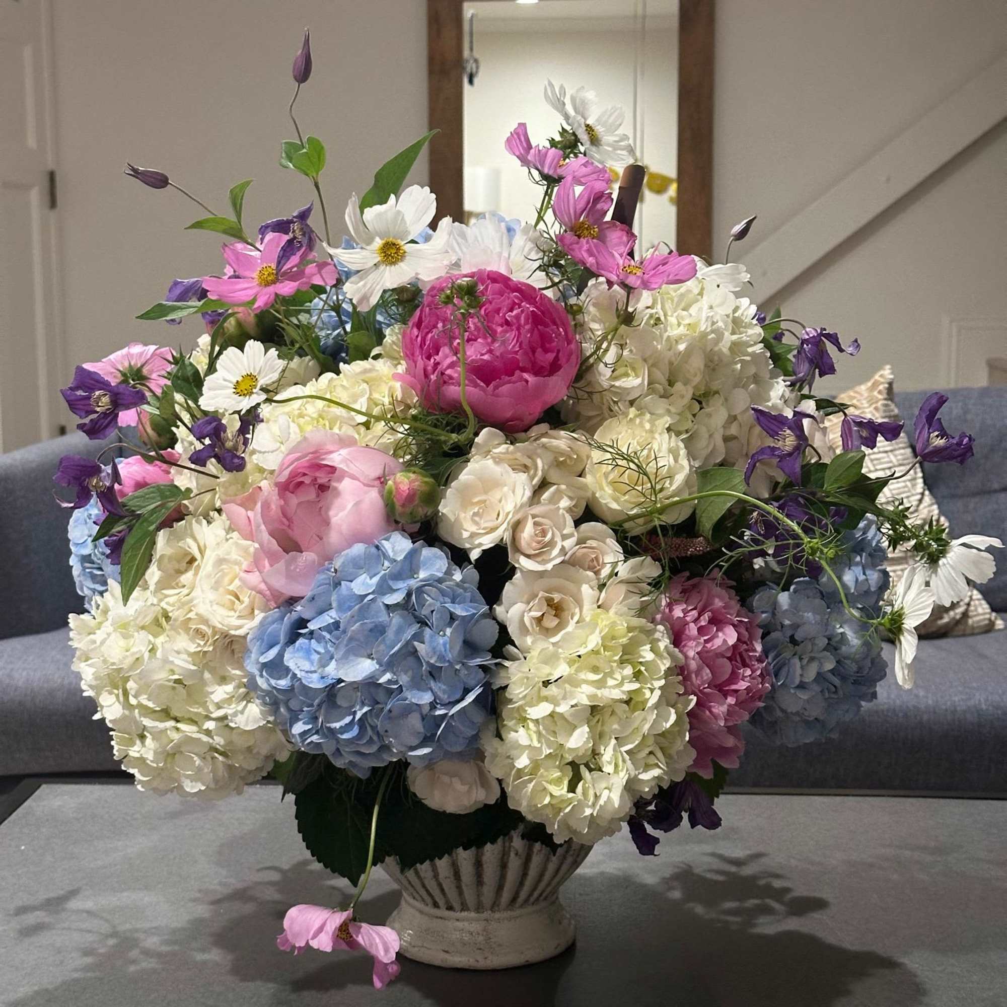 A grand, elegant arrangement in a timeless, classic pot. This majestic display