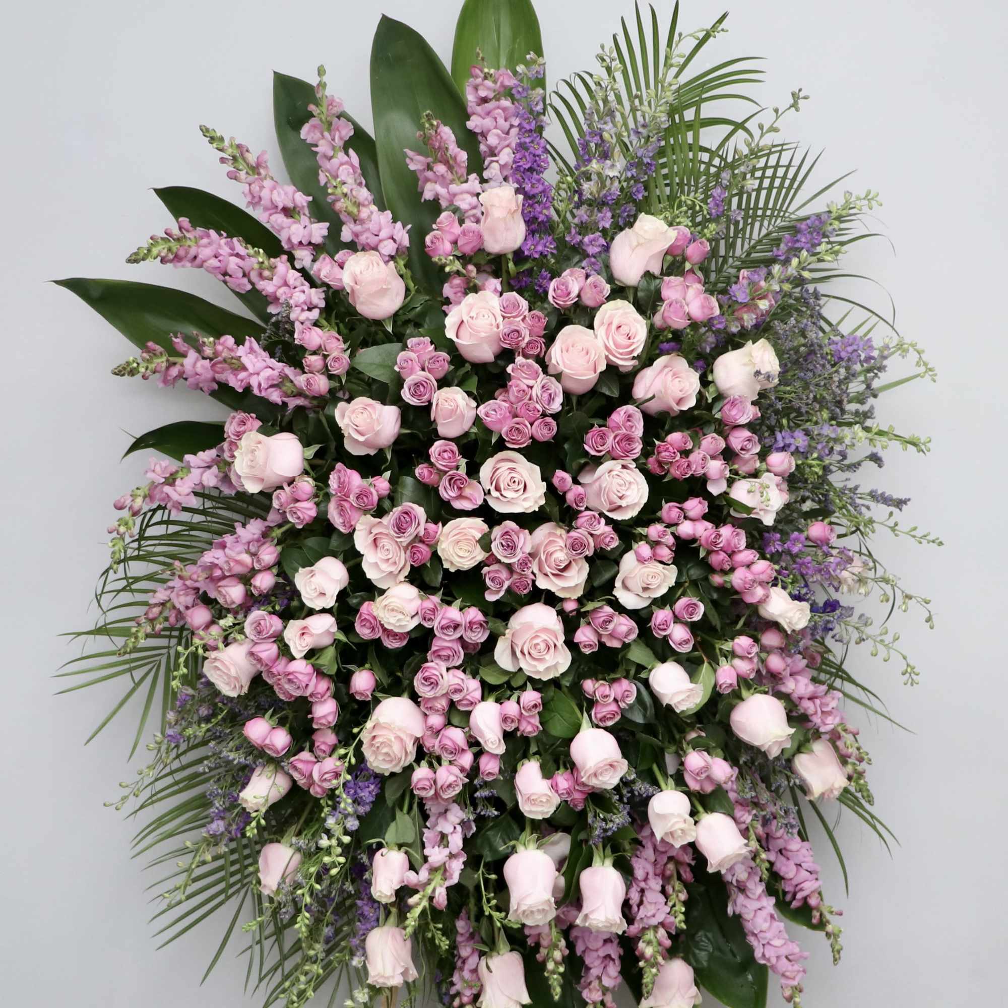 This spray contains a mix of pinks and lavender. All surrounded by