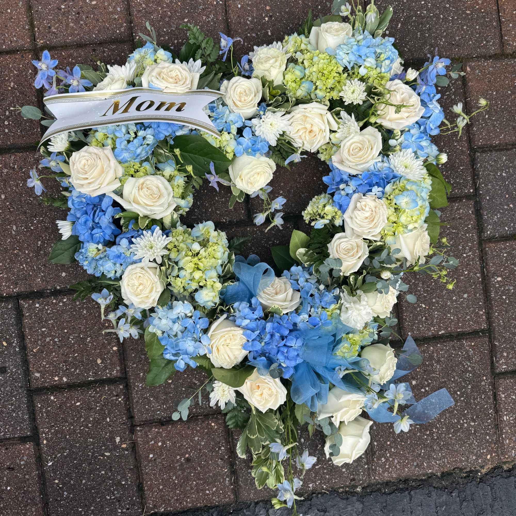 Open heart funeral piece with approximately 2 dozen roses. 