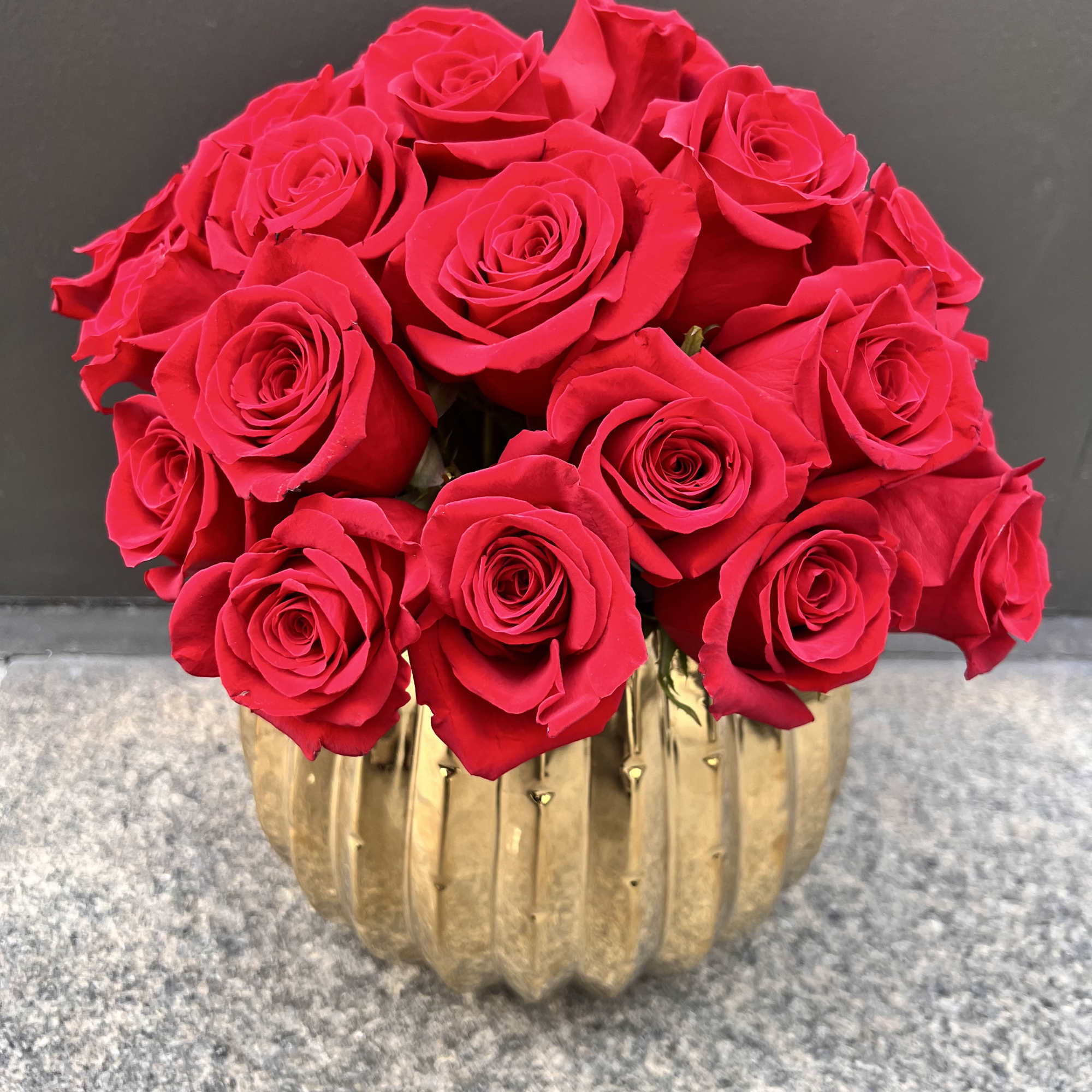 Premium Red Roses in a gold beautiful ceramic container.

