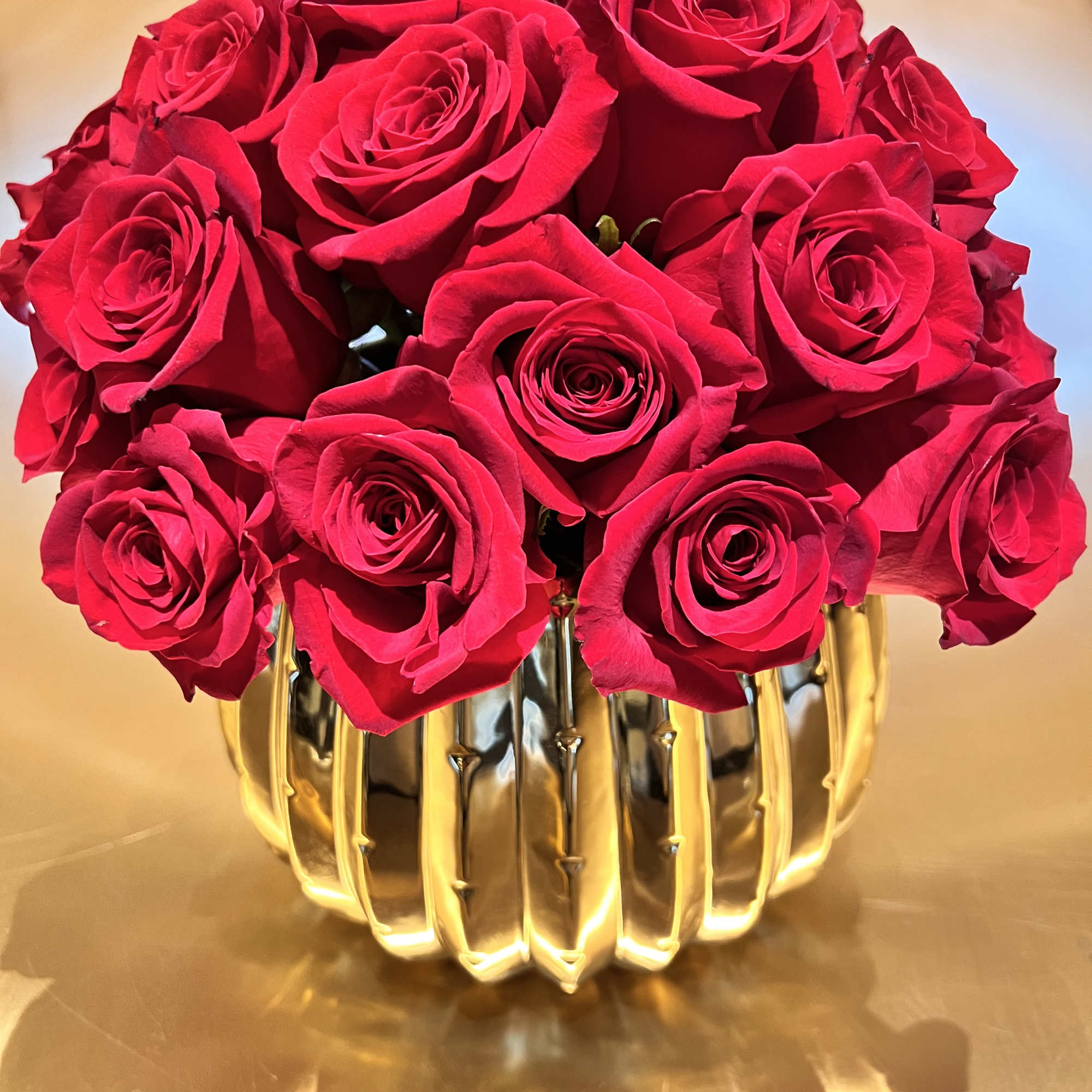 Premium Red Roses in a gold beautiful ceramic container.

