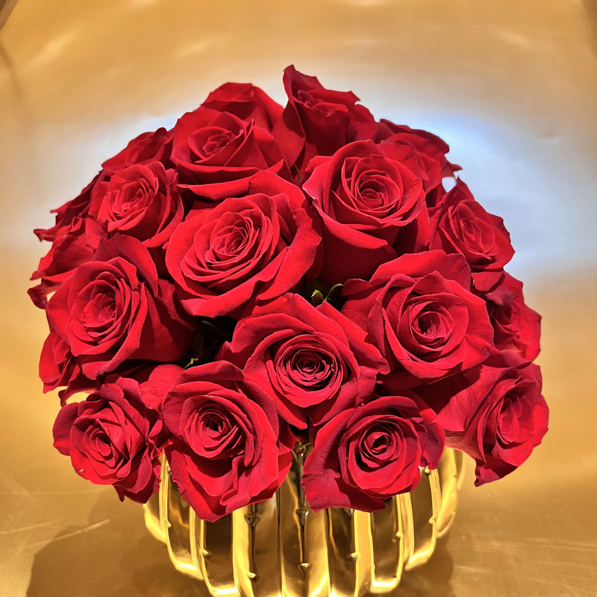 Premium Red Roses in a gold beautiful ceramic container.

