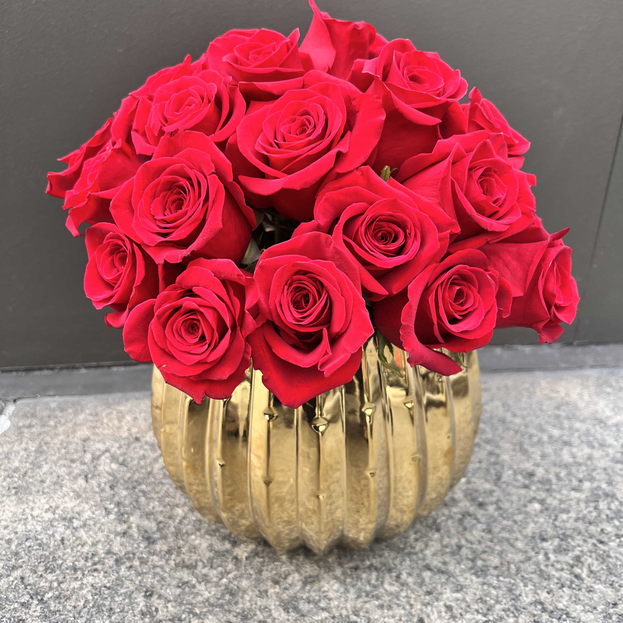 Premium Red Roses in a gold beautiful ceramic container.

