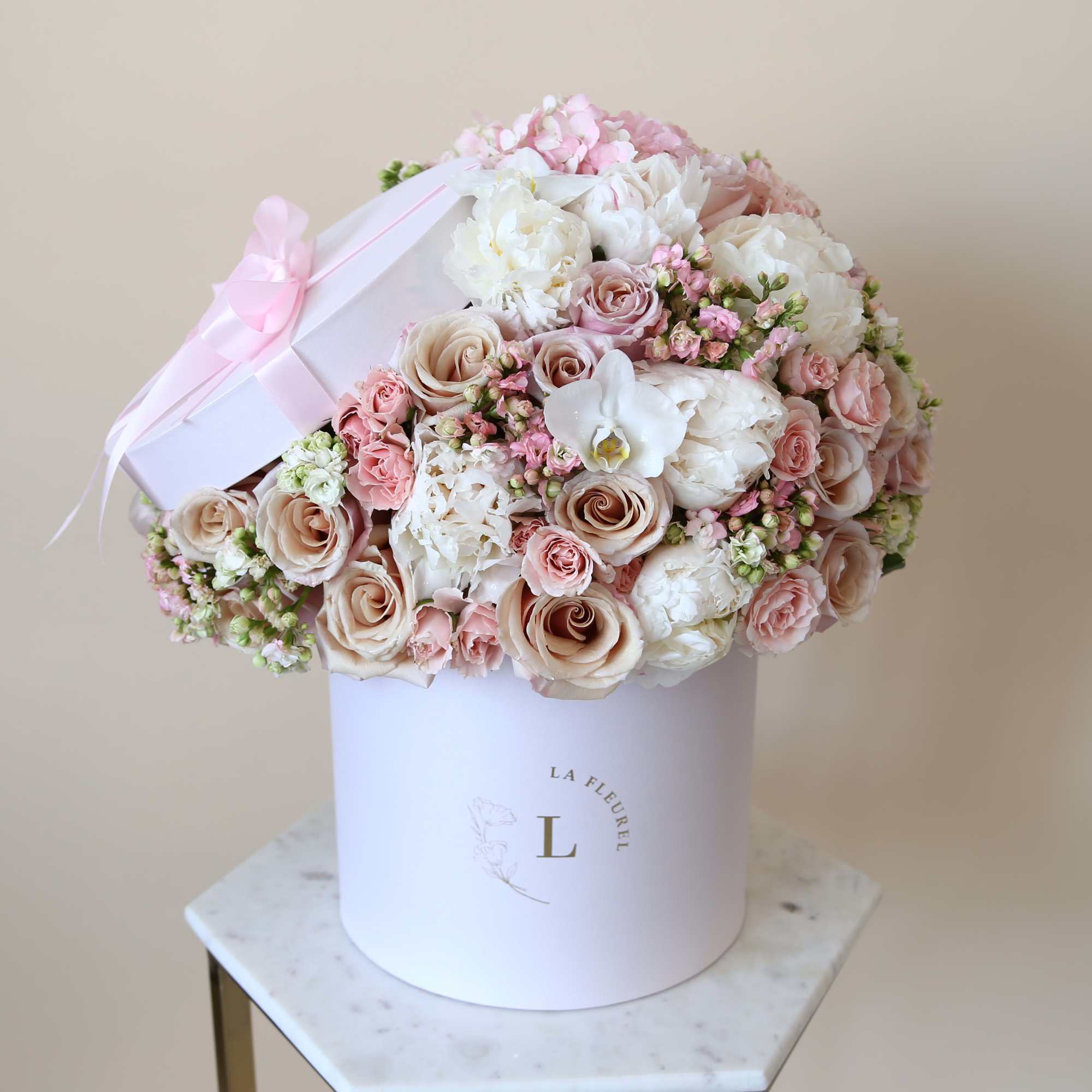 This delicate arrangement filled with the light pink and beige roses,hydrangeas, greens