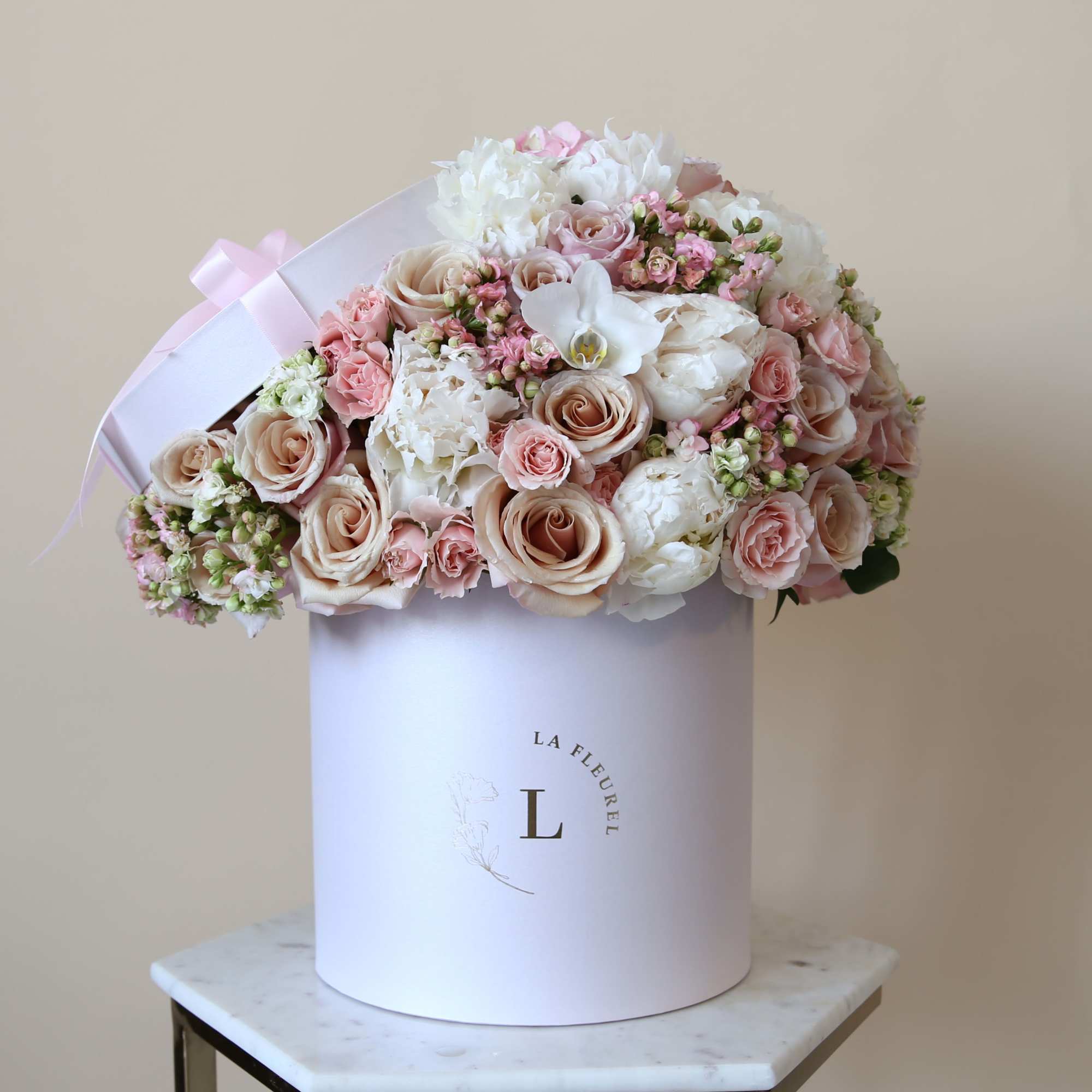 This delicate arrangement filled with the light pink and beige roses,hydrangeas, greens
