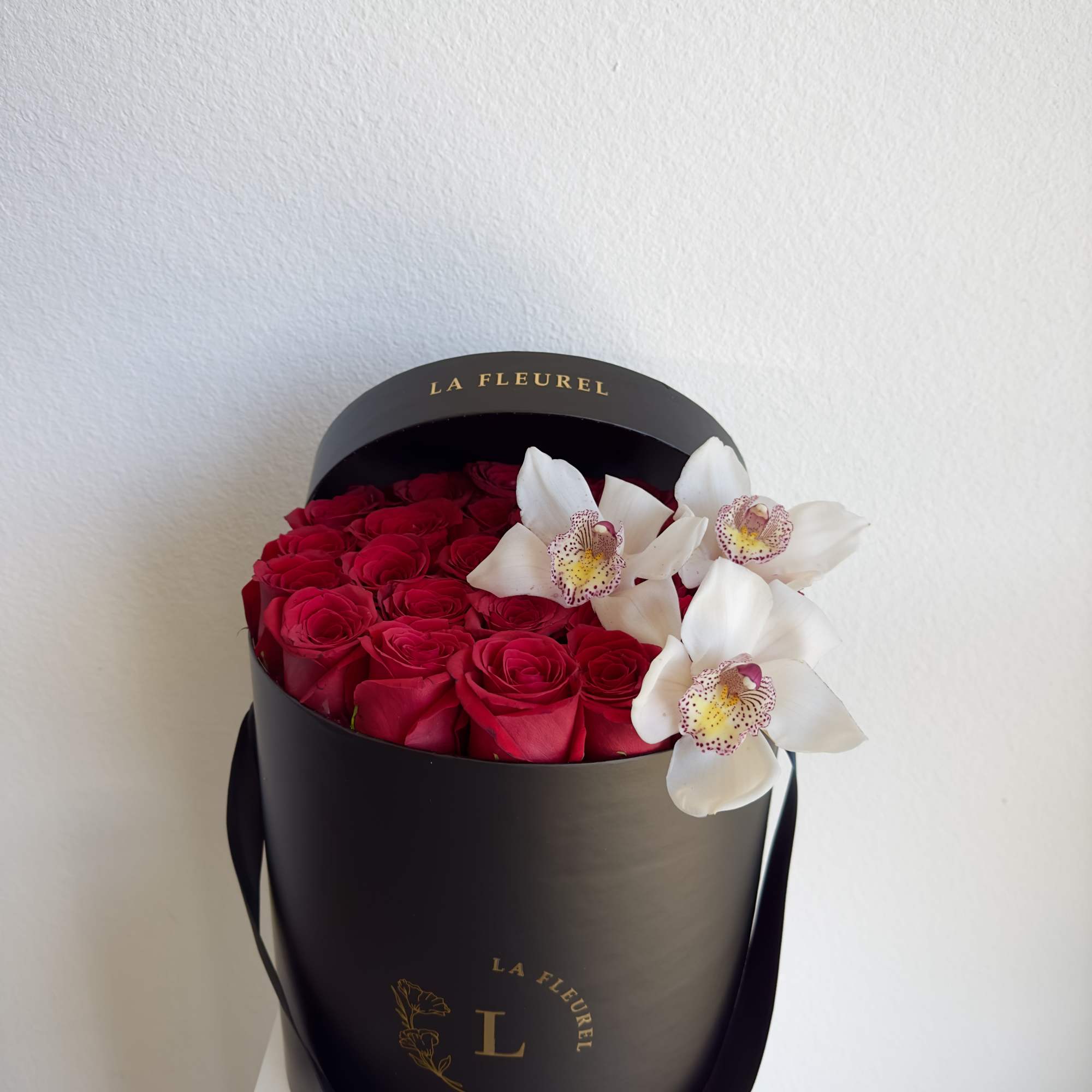 This beautiful arrangement filled with the red roses and orchids to deliver