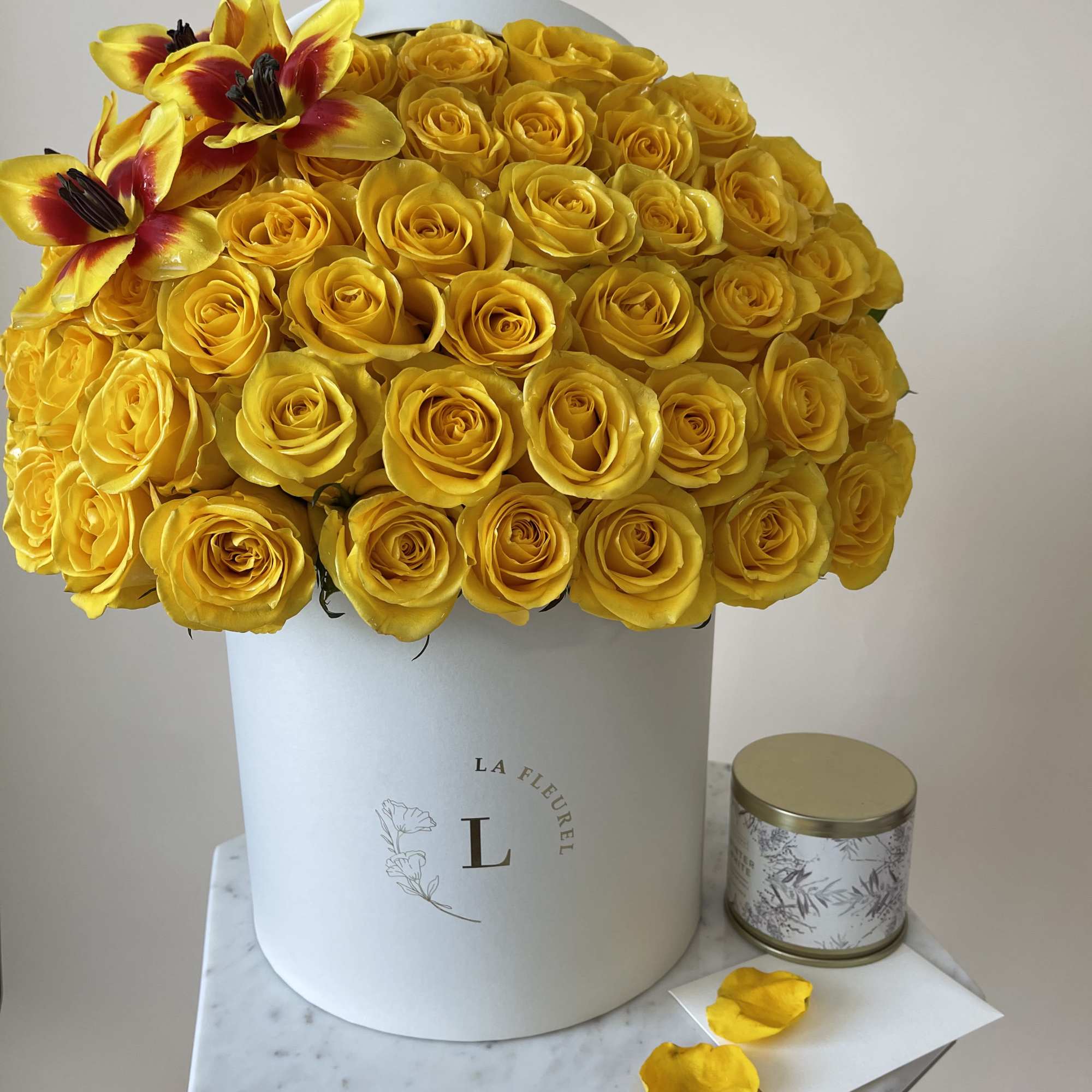 Yellow and glory in this composition are presented with roses and tulips.