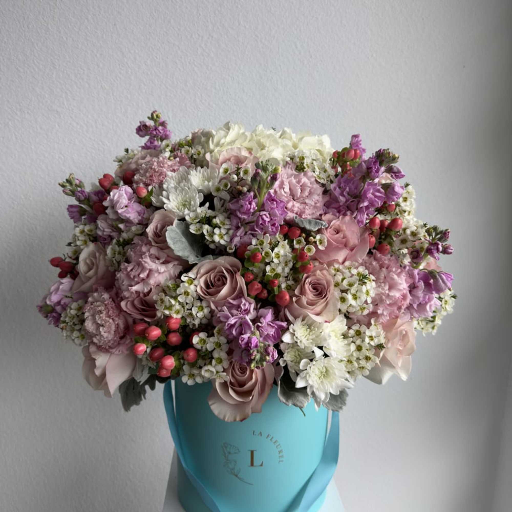 This beautiful arrangement is filled with pink roses, hydrangeas, stock, coffee beans