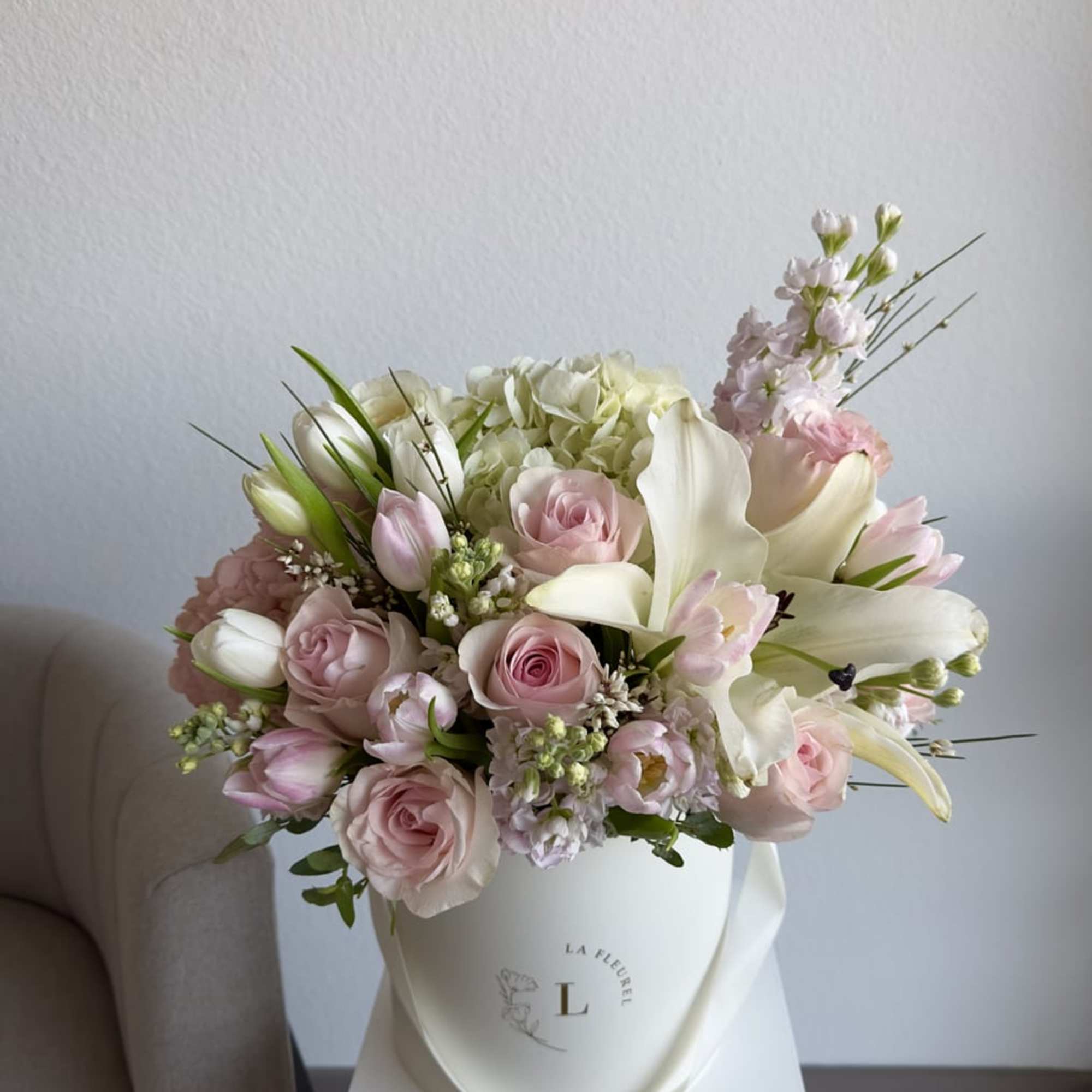 This romantic arrangement includes roses, spray roses, tulips, lilies and greens.

Perfect for