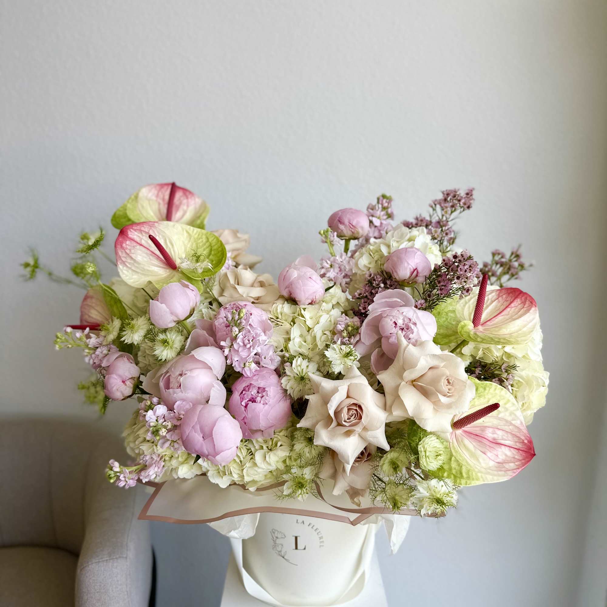 This romantic arrangement includes roses, hydrangeas, peonies, anthurium and greens.

Perfect for any