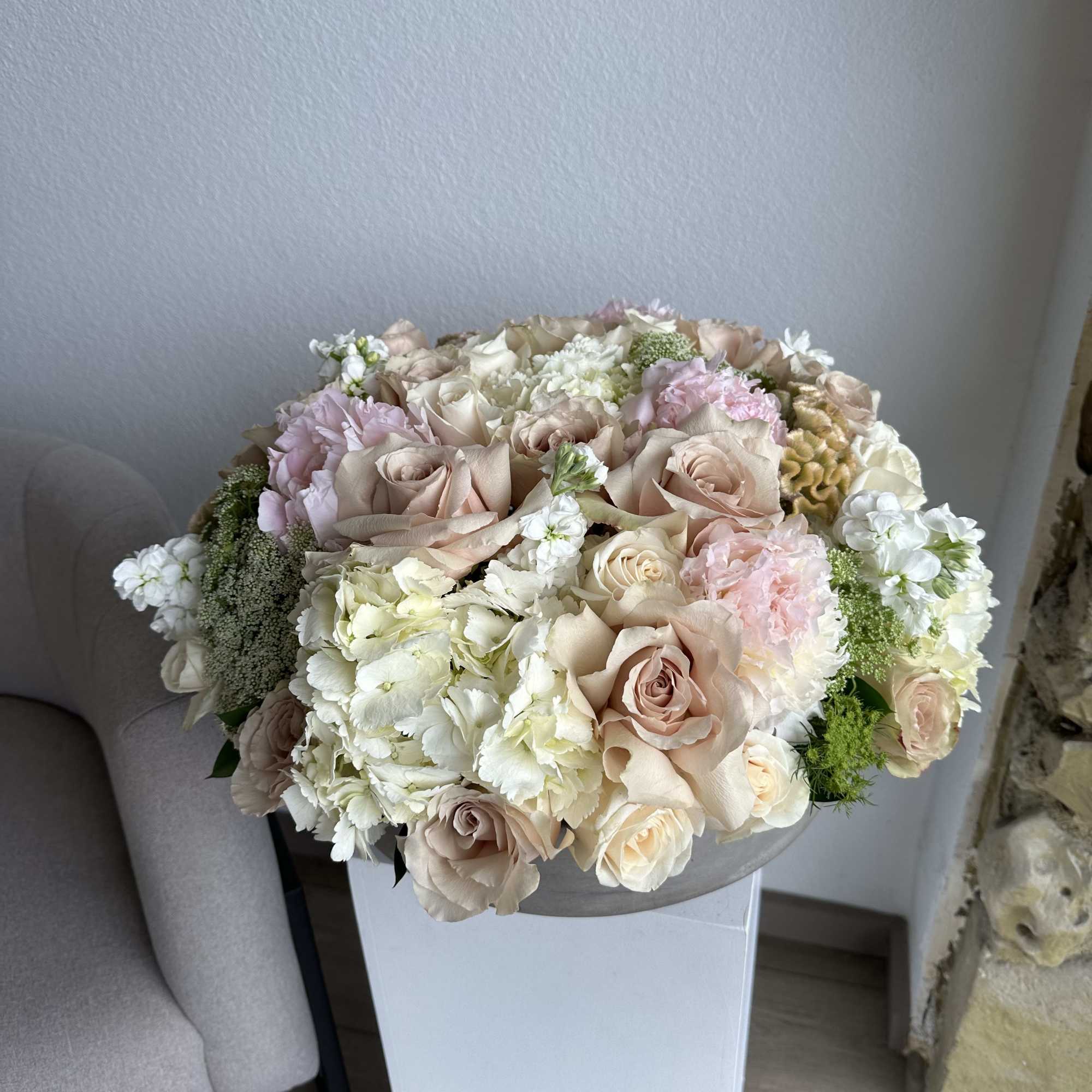 This beautiful arrangement filled with the roses, hydrangeas, peonies and greens to