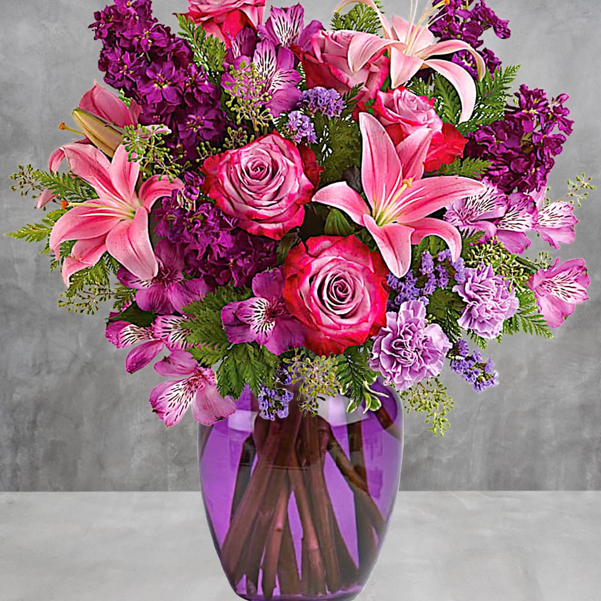 Like a rare jewel, this regal arrangement of lavender roses and pink