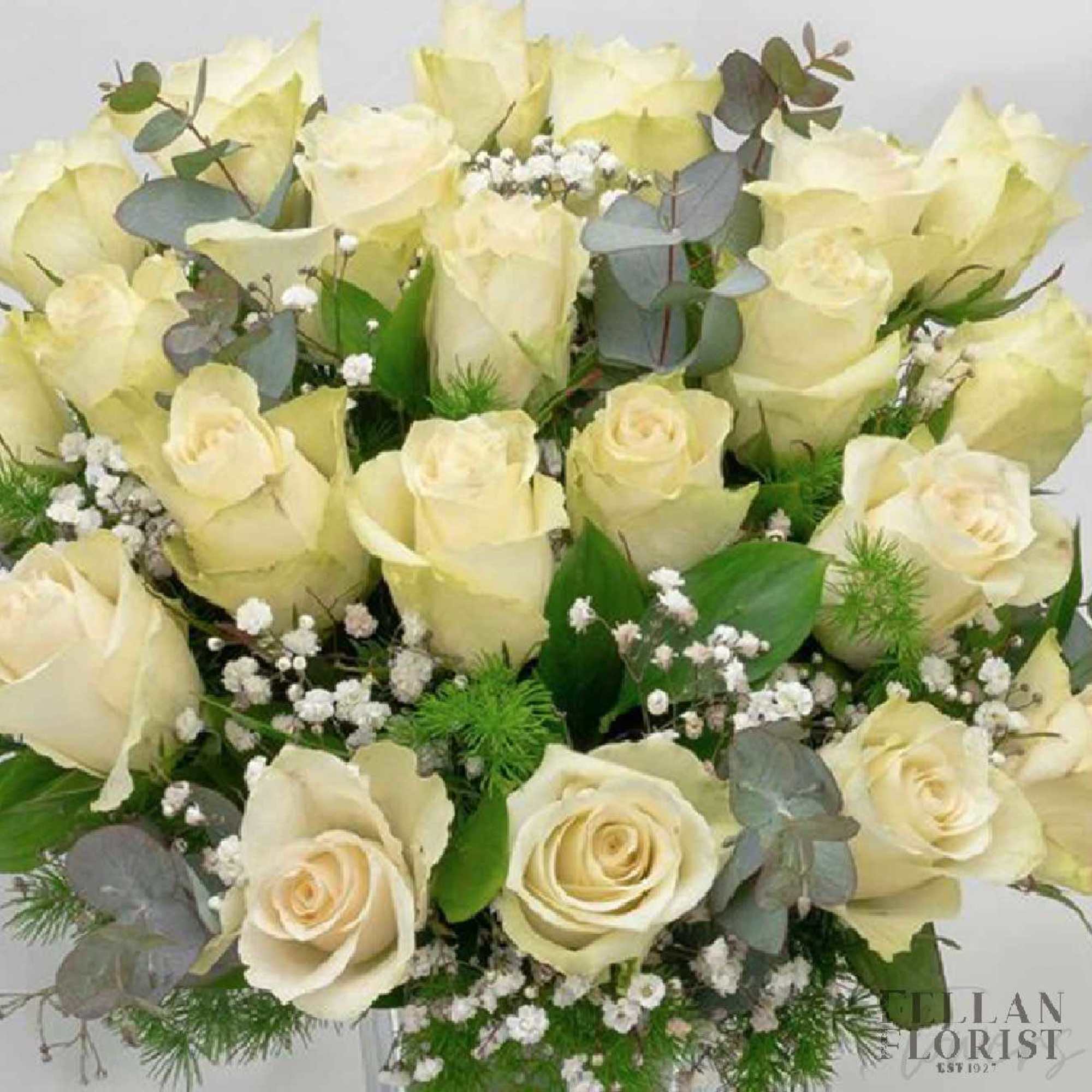 24 Long-stem white roses in a vase  24 Long-stem white roses in a vase