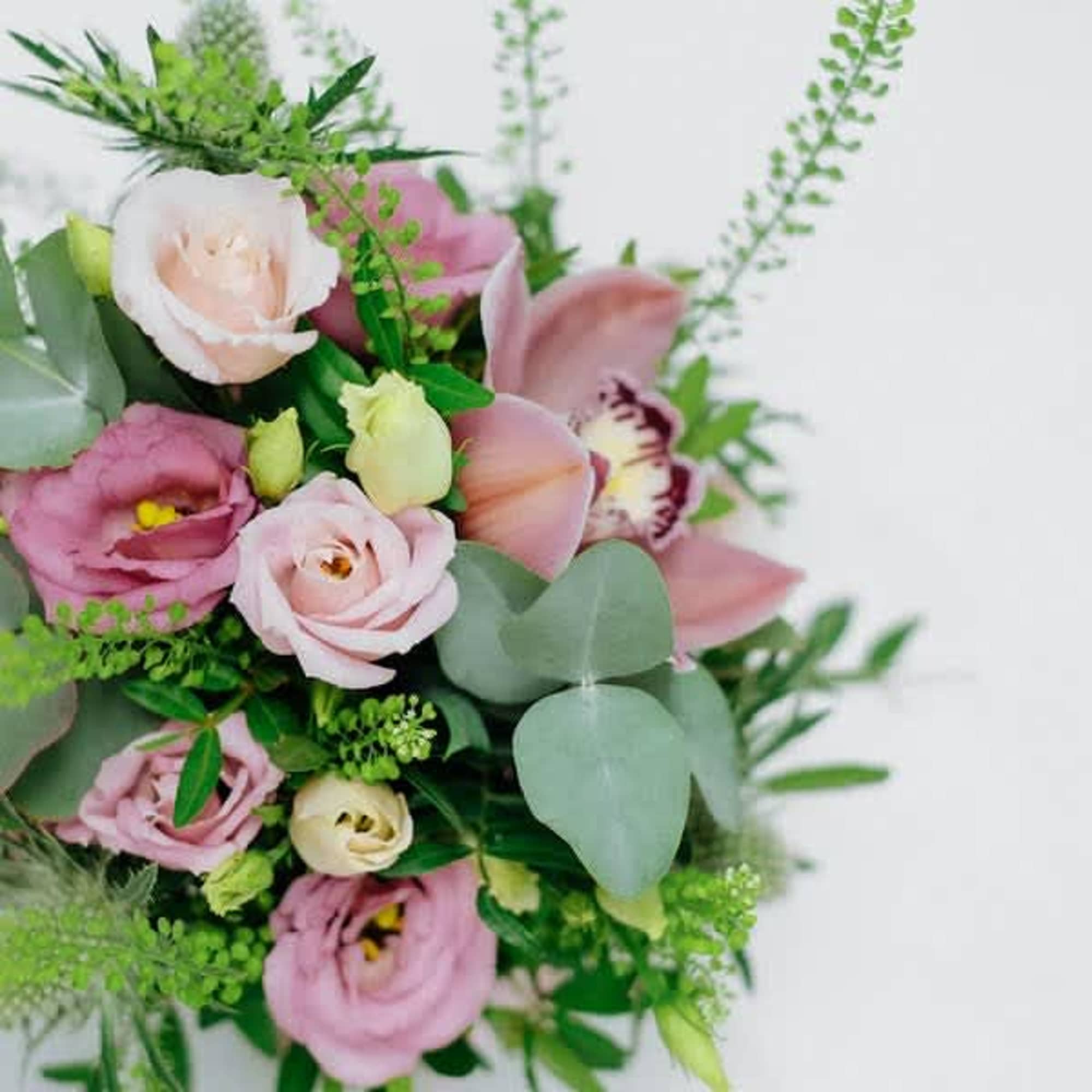 The cutest pink-themed bouquet crammed with red cymbidium, pink lisianthus, Thistle, and The cutest pink-themed bouquet crammed with red cymbidium, pink lisianthus, Thistle, and