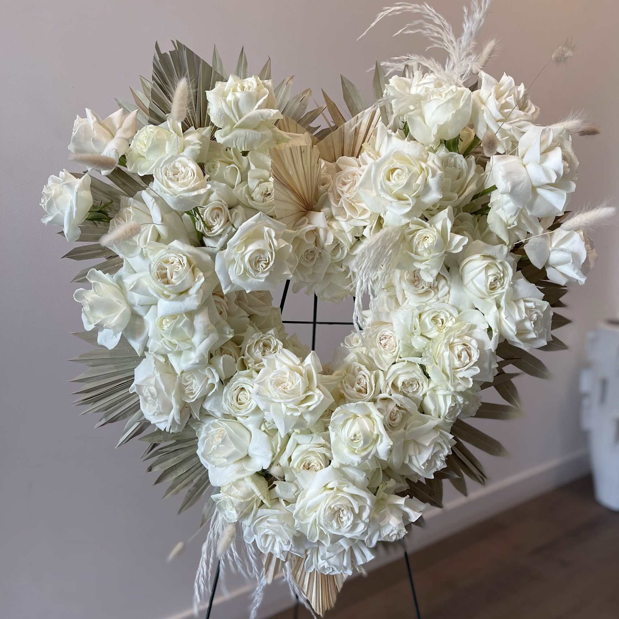 - Elegant heart-shaped design
- Pure white roses symbolizing peace and love
- Subtle