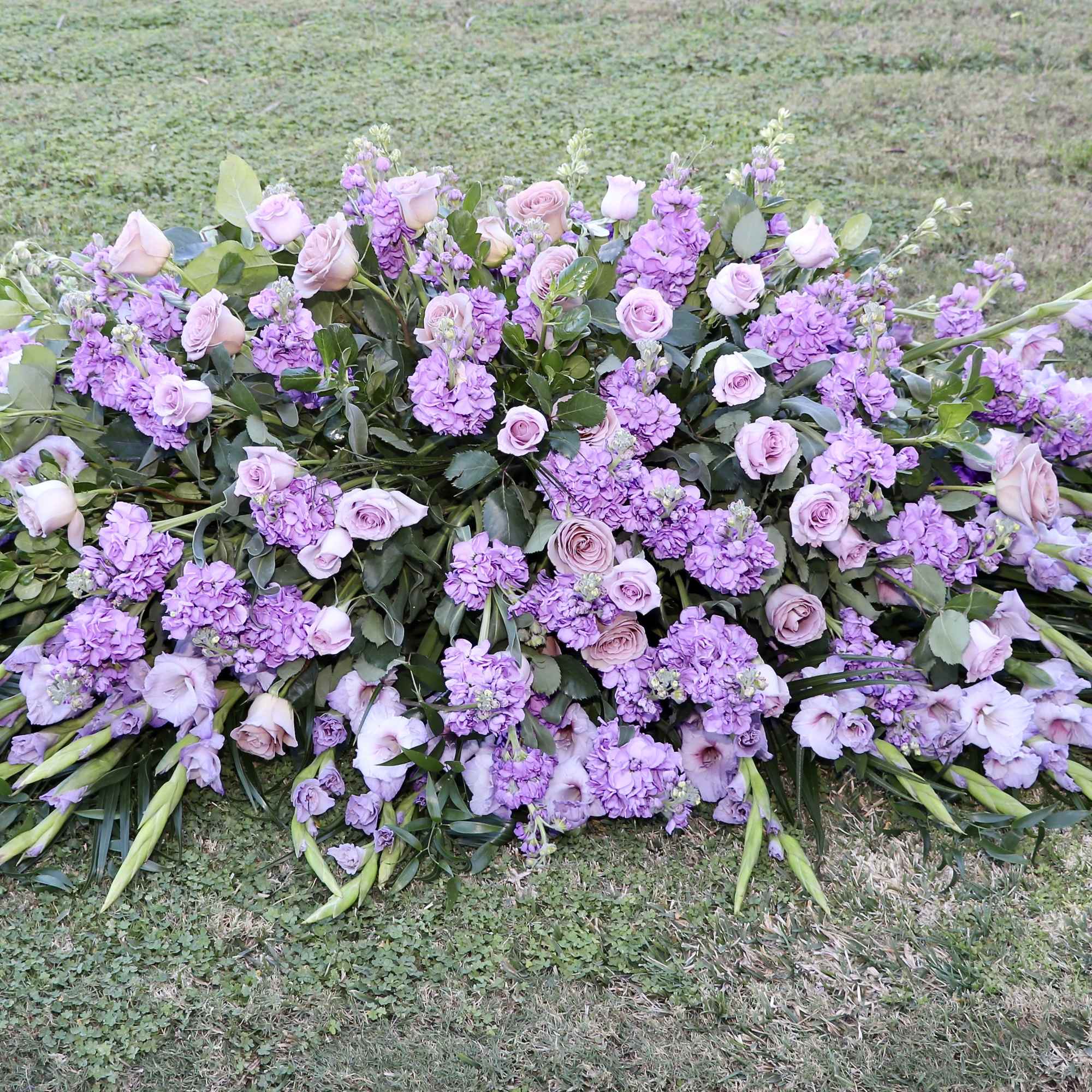 This casket is made with seasonal lavender flowers and greens.

Standard size is