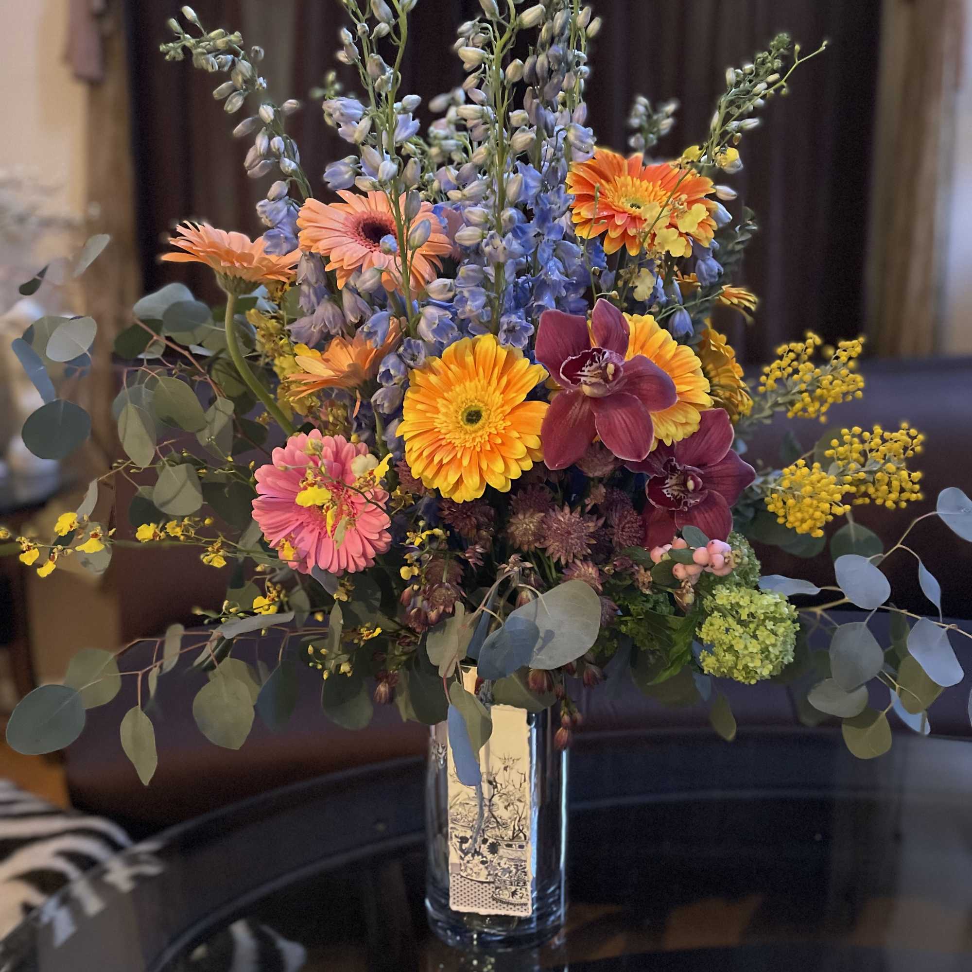 This beautiful flower arrangement features vibrant gerbera daisies, symbolizing new beginnings, family