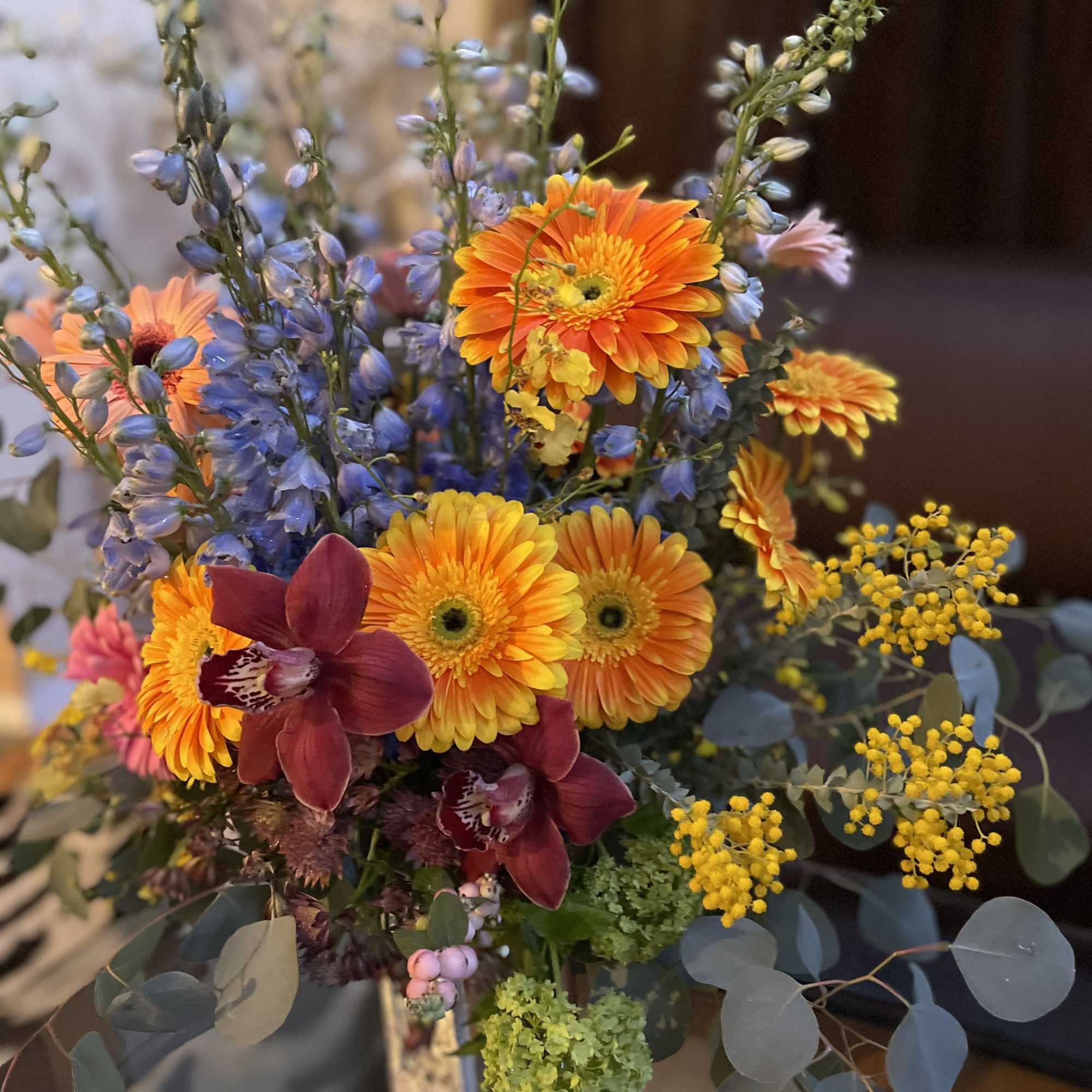 This beautiful flower arrangement features vibrant gerbera daisies, symbolizing new beginnings, family