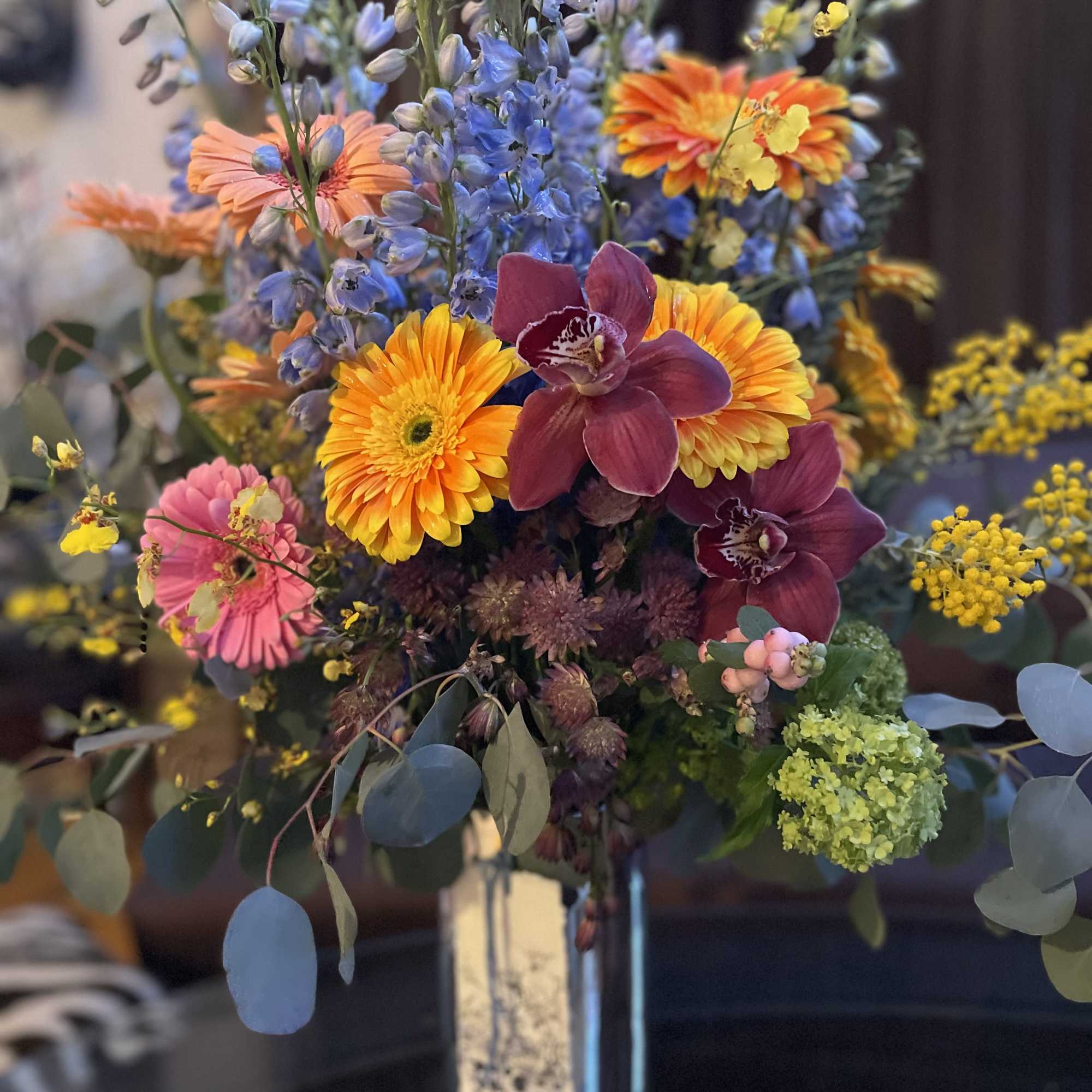 This beautiful flower arrangement features vibrant gerbera daisies, symbolizing new beginnings, family