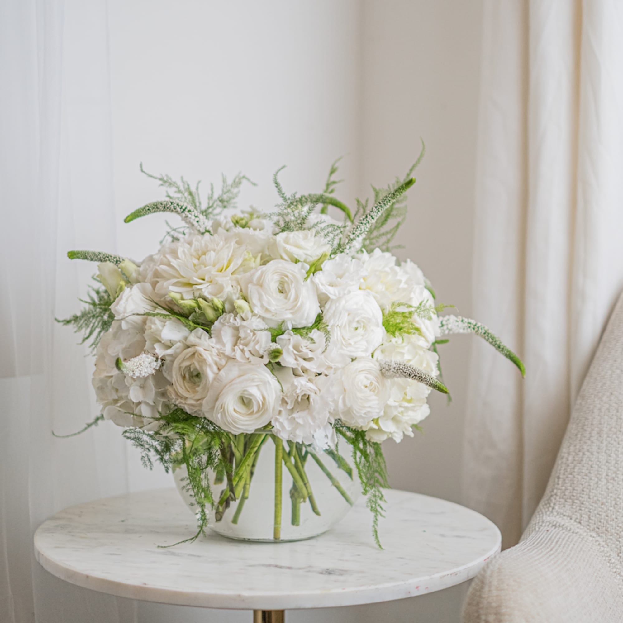 This white dahlias and rununculuses arrangement in delicate fresh colors looks very
