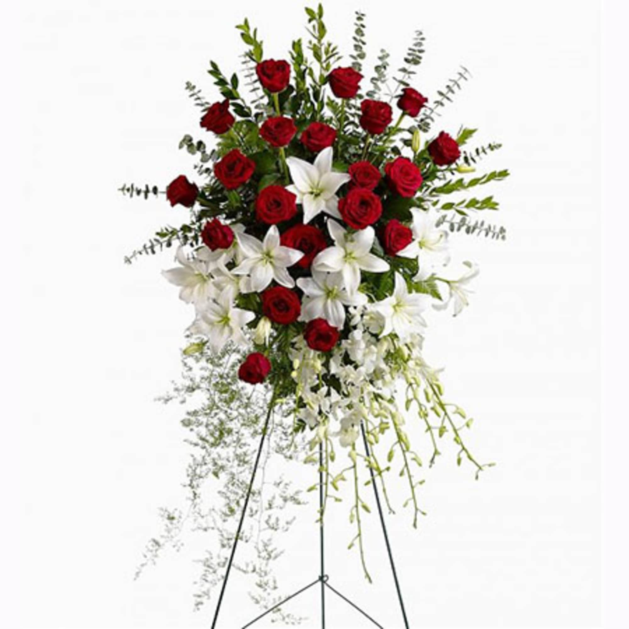 Red roses, white asiatic lilies and delicate dendrobium orchids are accented with
