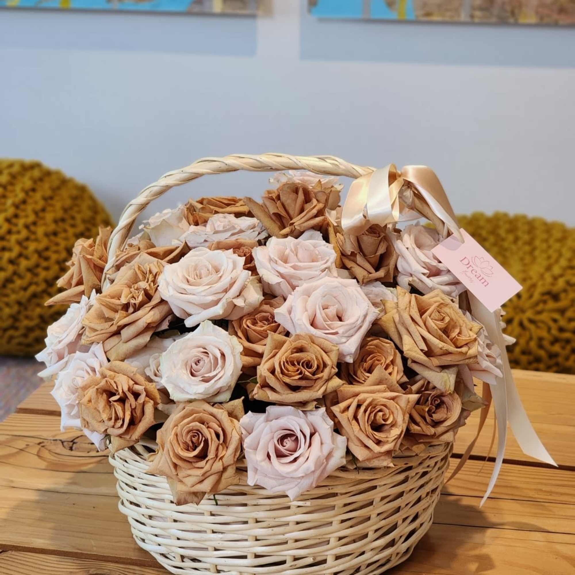 Exquisite floral arrangement, where cream roses intertwine with caramel blooms in a