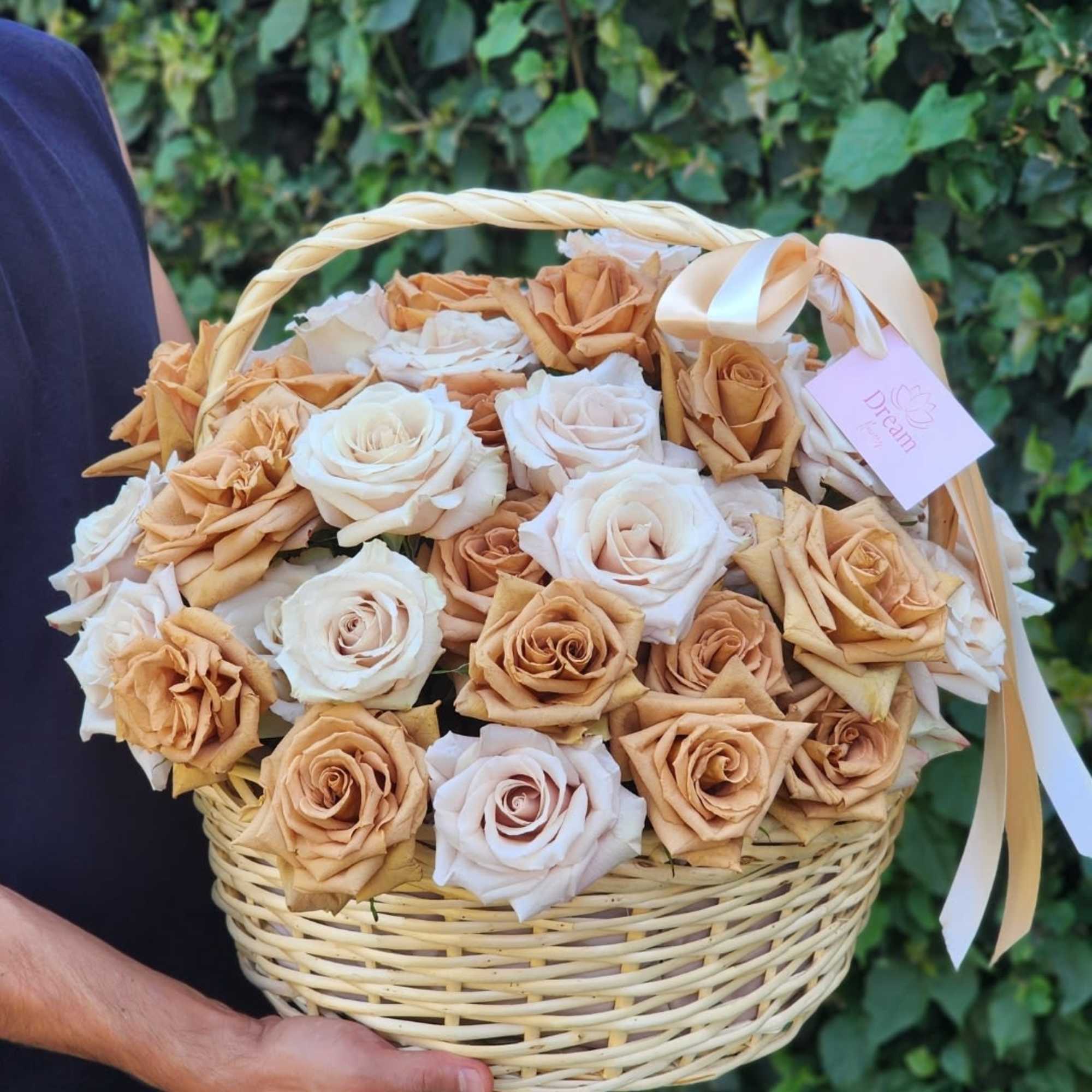 Exquisite floral arrangement, where cream roses intertwine with caramel blooms in a