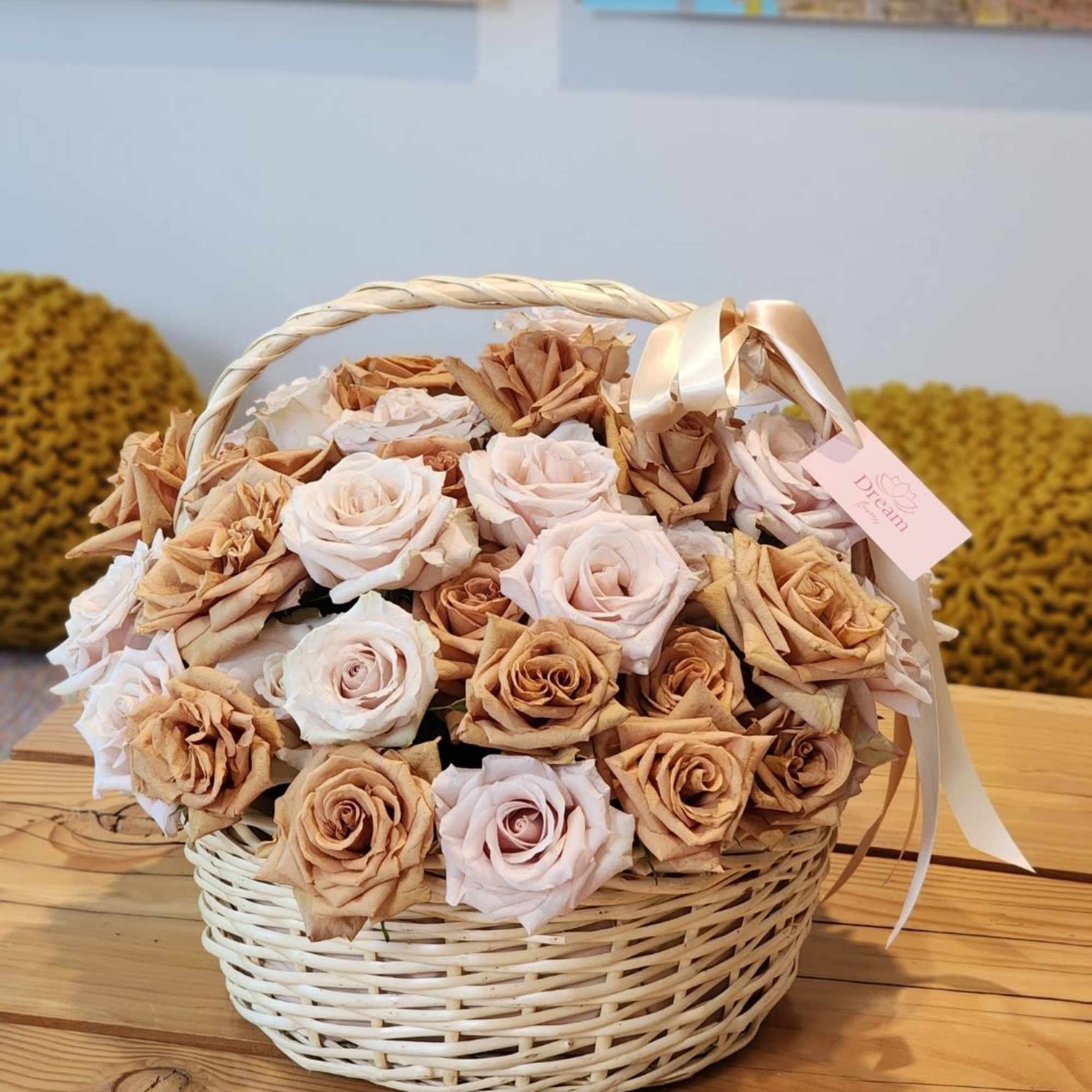 Exquisite floral arrangement, where cream roses intertwine with caramel blooms in a