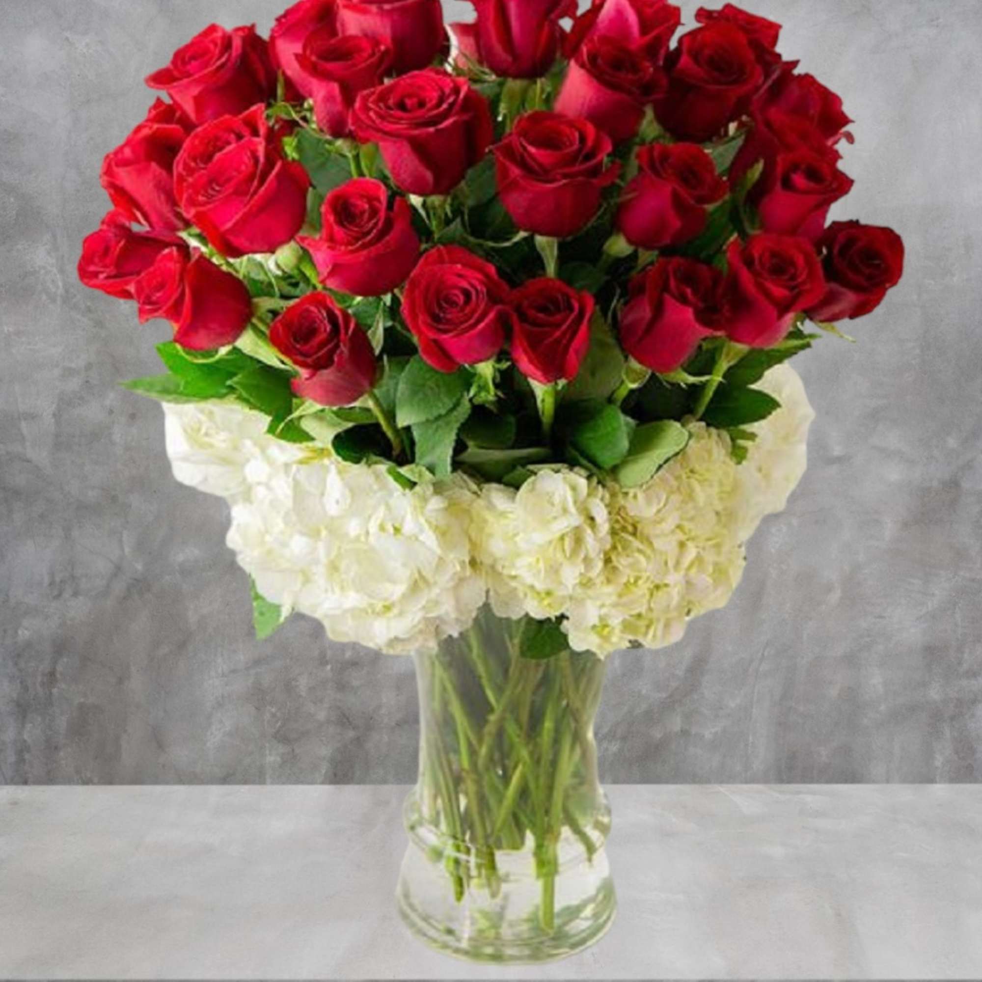 Send this luxury red rose arrangement wrapped in white hydrangeas. 

DETAILS
Beautiful velvety